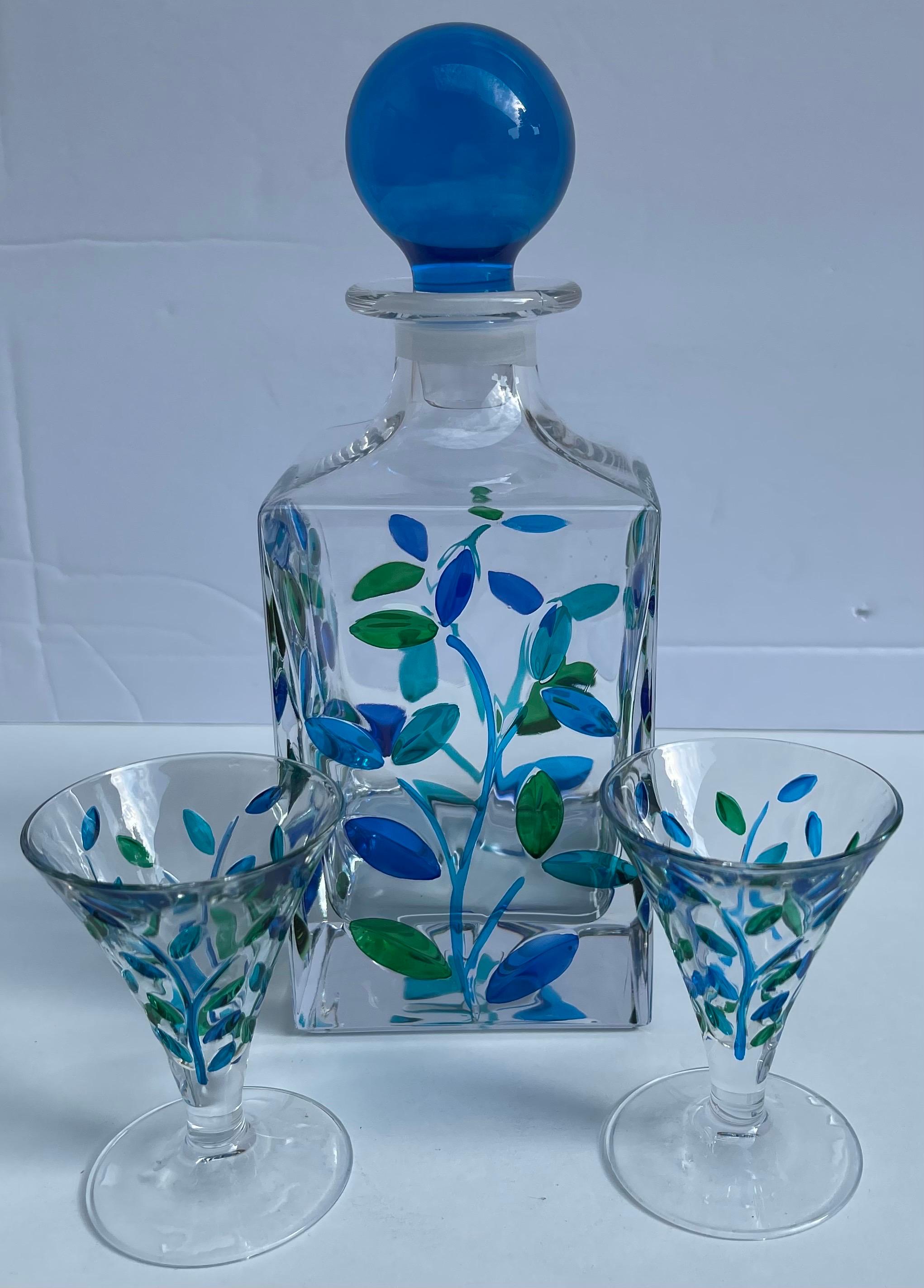 Venetian painted glass decanter with two matching shot glasses. Decanter has a blue blown glass stopper. Each piece features hand painted blue/green leaf design. 

Each glass measures: 3.5” tall x 2.25” wide 

No makers mark or signature, this set