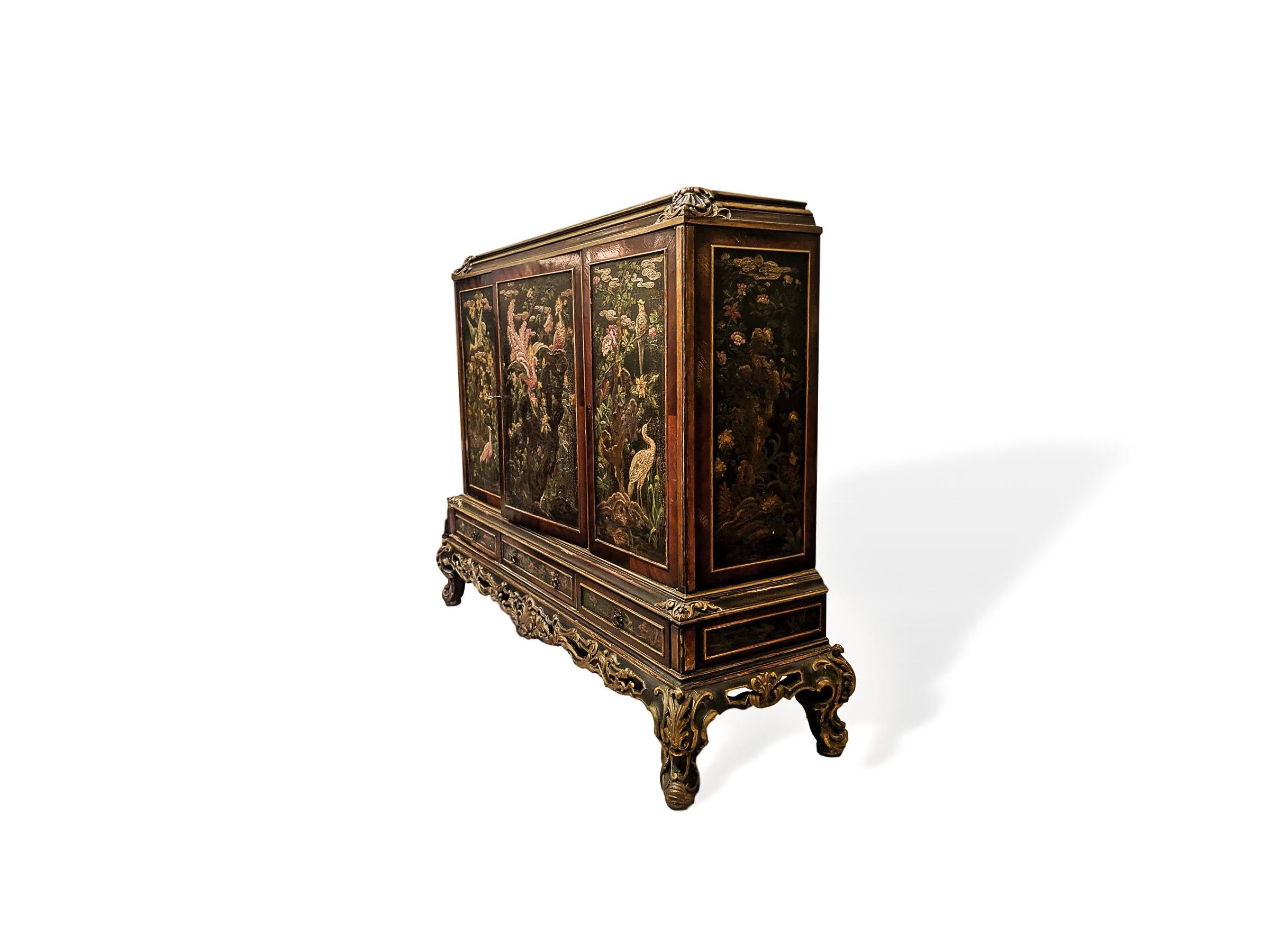 Venetian painted parcel-gilt chinoiserie bar drinks cabinet, Italian, circa 1920, hand painted decoration throughout with exotic and stylized birds in a lush bloom filled oriental garden setting, with gilded tracery to the hand carved Rococo base,
