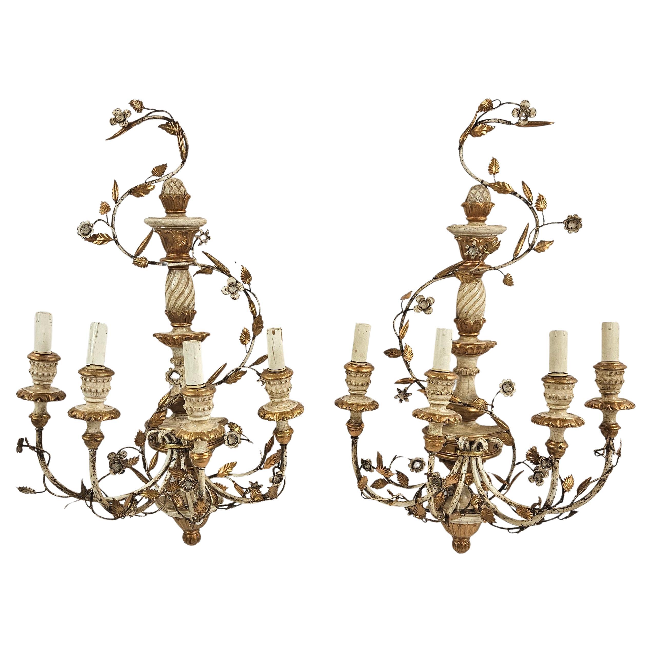 Beautiful pair of handcrafted Italian Rococo wall sconces dating from the 1950s. These ornate fixtures feature richly detailed scrollwork, carved flourishes, and delicate floral accents typical of how the original 18th century sconces of the Rococo
