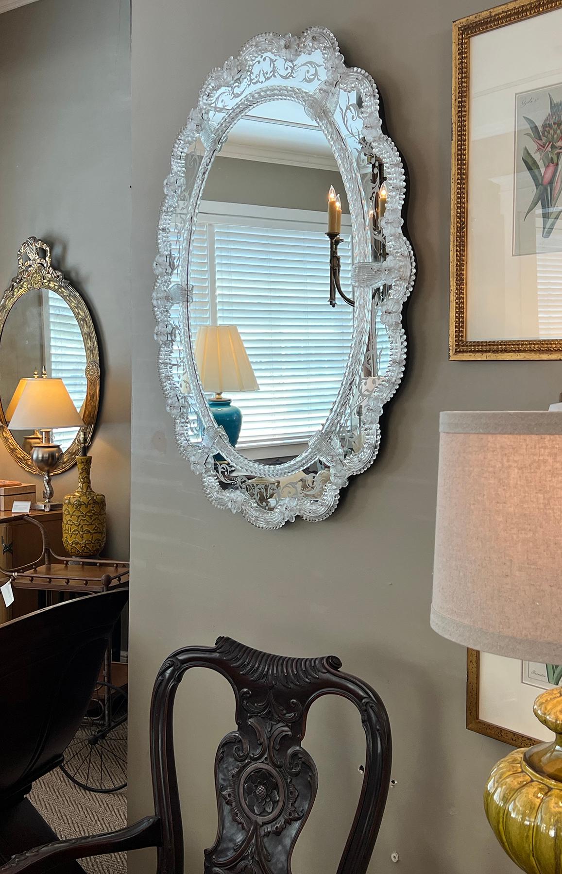 the oval central plate surrounded by a scalloped reverse-etched mirrored border adorned with twisted glass rods and C-scrolls all attached with glass rosettes and leaves