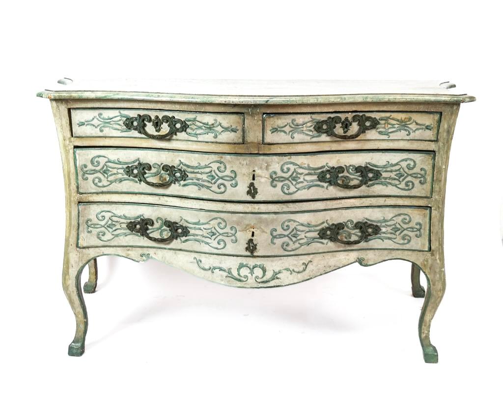 Late 18th or early 19th Century Venetian Painted Commode. Commode features a serpentine front and faux marble top. Chest has two smaller drawers over two large drawers. Painted with blue scrolling and garland on off-white background. Original brass
