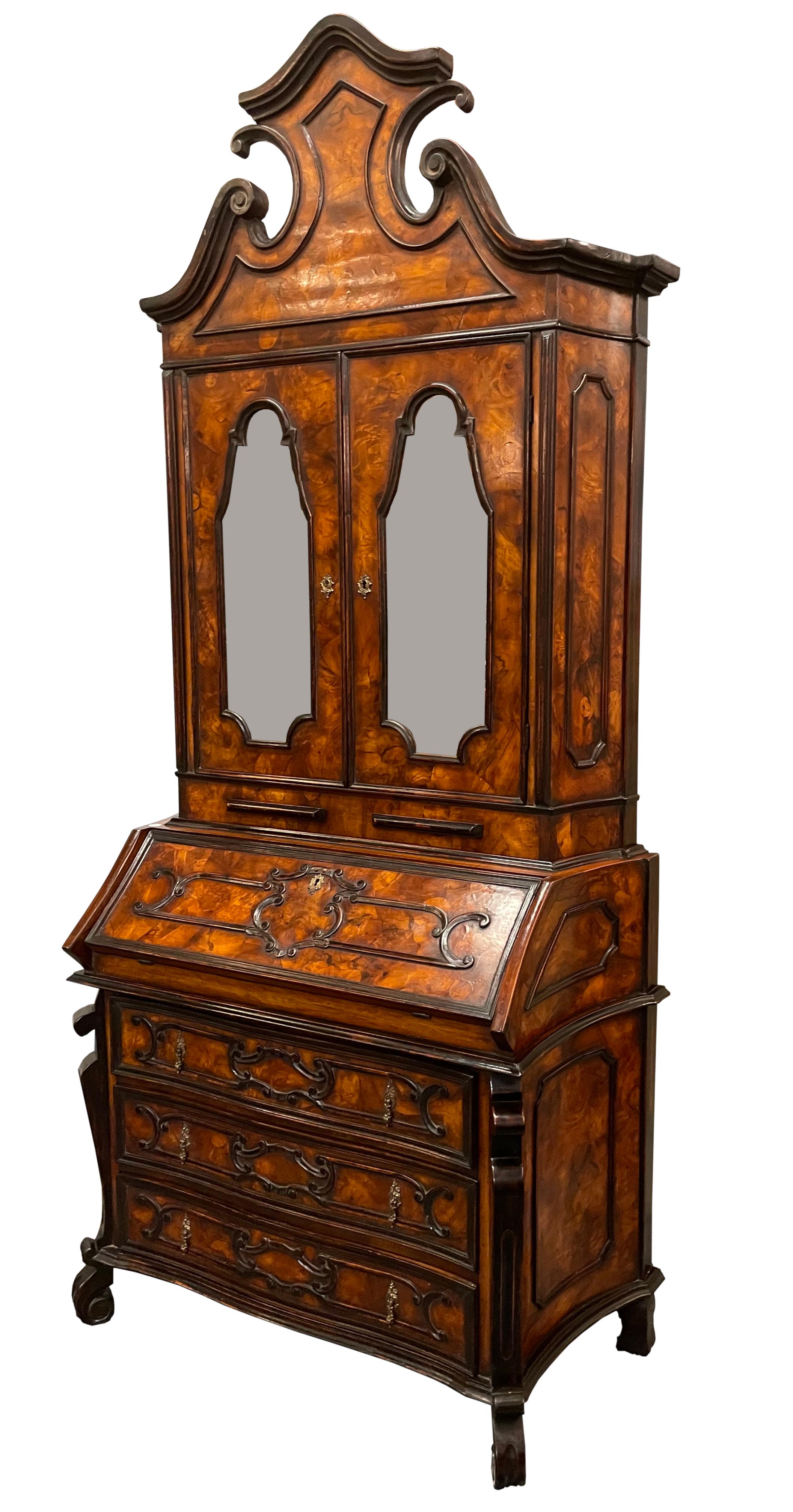 
Venetian Rococo Style Burl Walnut Secretary Bookcase
In two parts, The upper with a molded serpentine cresting incorporating a swans neck cornice, above two mirror-inset shaped doors, opening to shelves, above candle slides, the lower part with a
