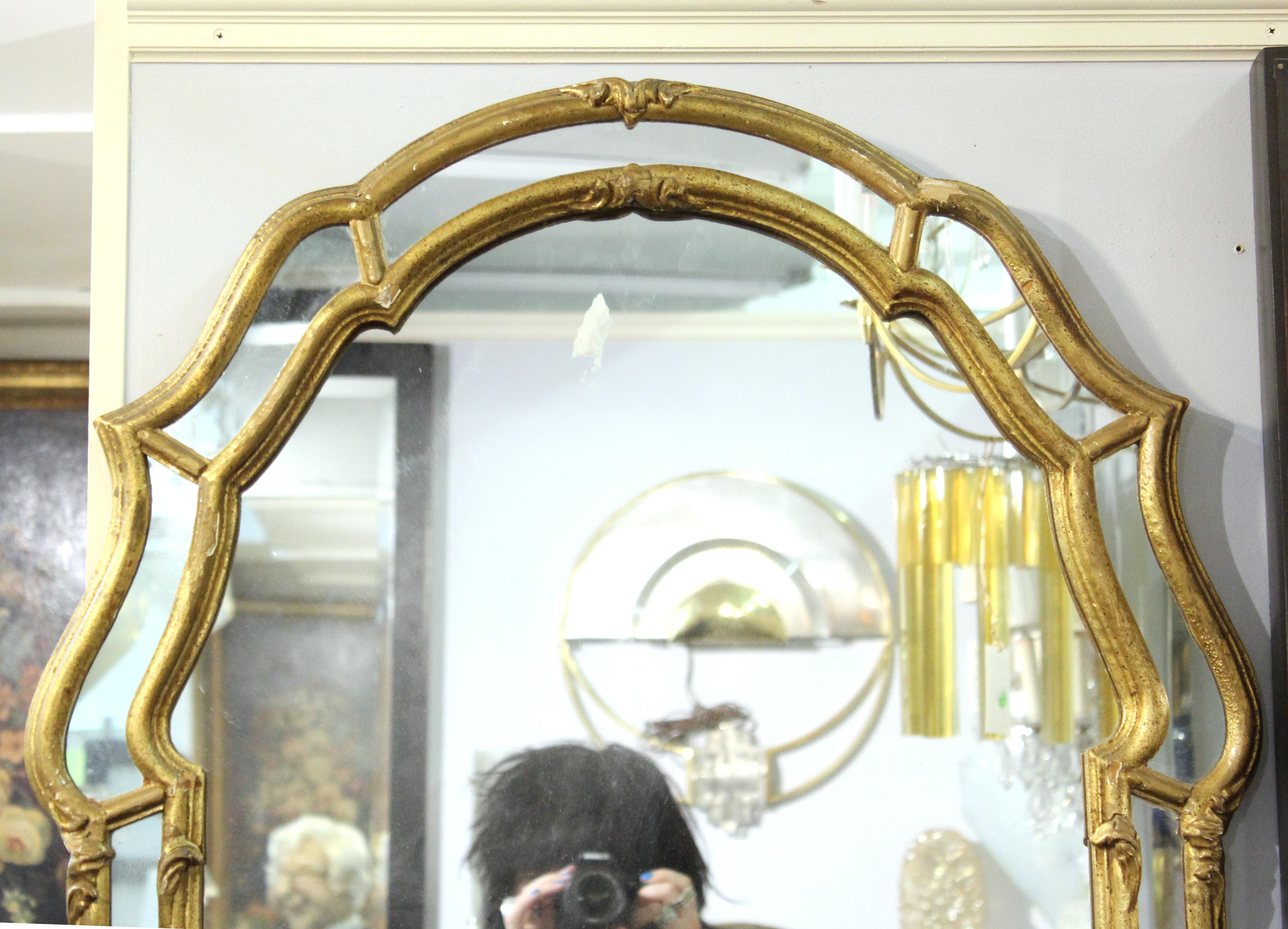 Venetian Rococo style giltwood mirror, the framed bordered with panels. Measures: 44” H x 26” W x 1.5” D.