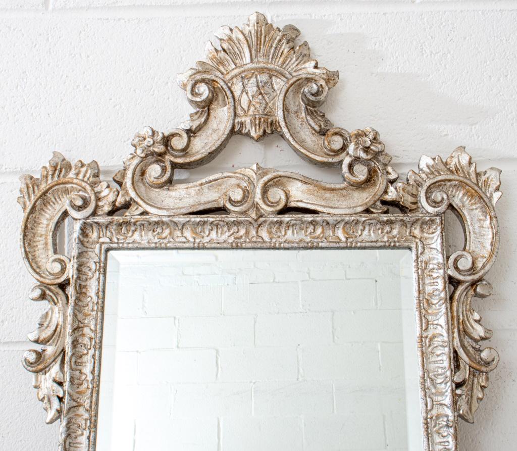 Venetian Rococo style silvered mirror with rocaille-form crest rail above similarly scrolling sides, centering a beveled rectangular mirrored plate.

Dimensions: Mirror: 21
