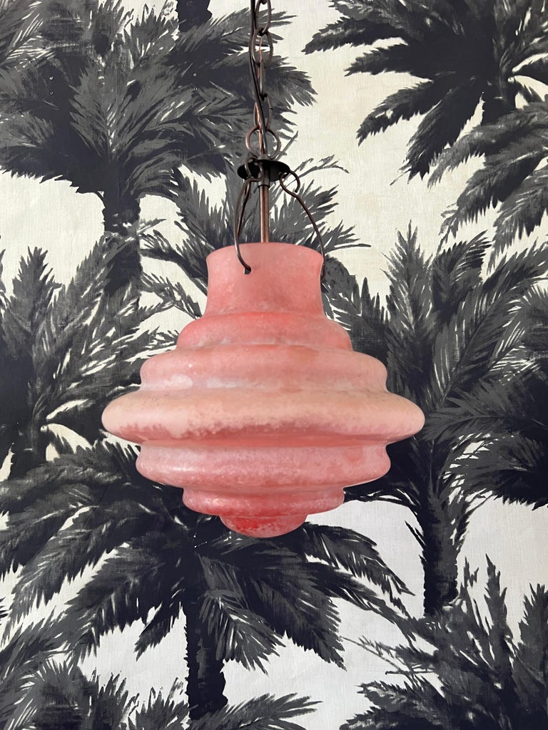 Venetian blown glass pendant light with acid etched finish in salmon pink. Scavo is a technique using high heat to create a weathered archeological finish to the glass. 
This Organic Modernist pendant evokes both a Moorish and Turkish Ottoman