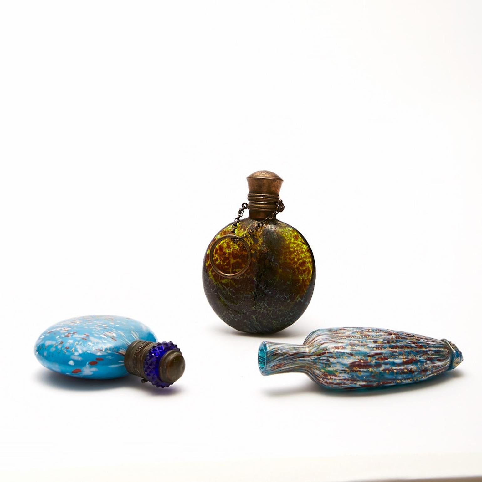 Four Chatelaine Venetian Scent Bottles circa 1870-1890 blown glass made by the late 19th Century glass masters of Murano.
The three smallest are internally decorated with gold powders and two of them have gilt metal mounts. One of the mount is