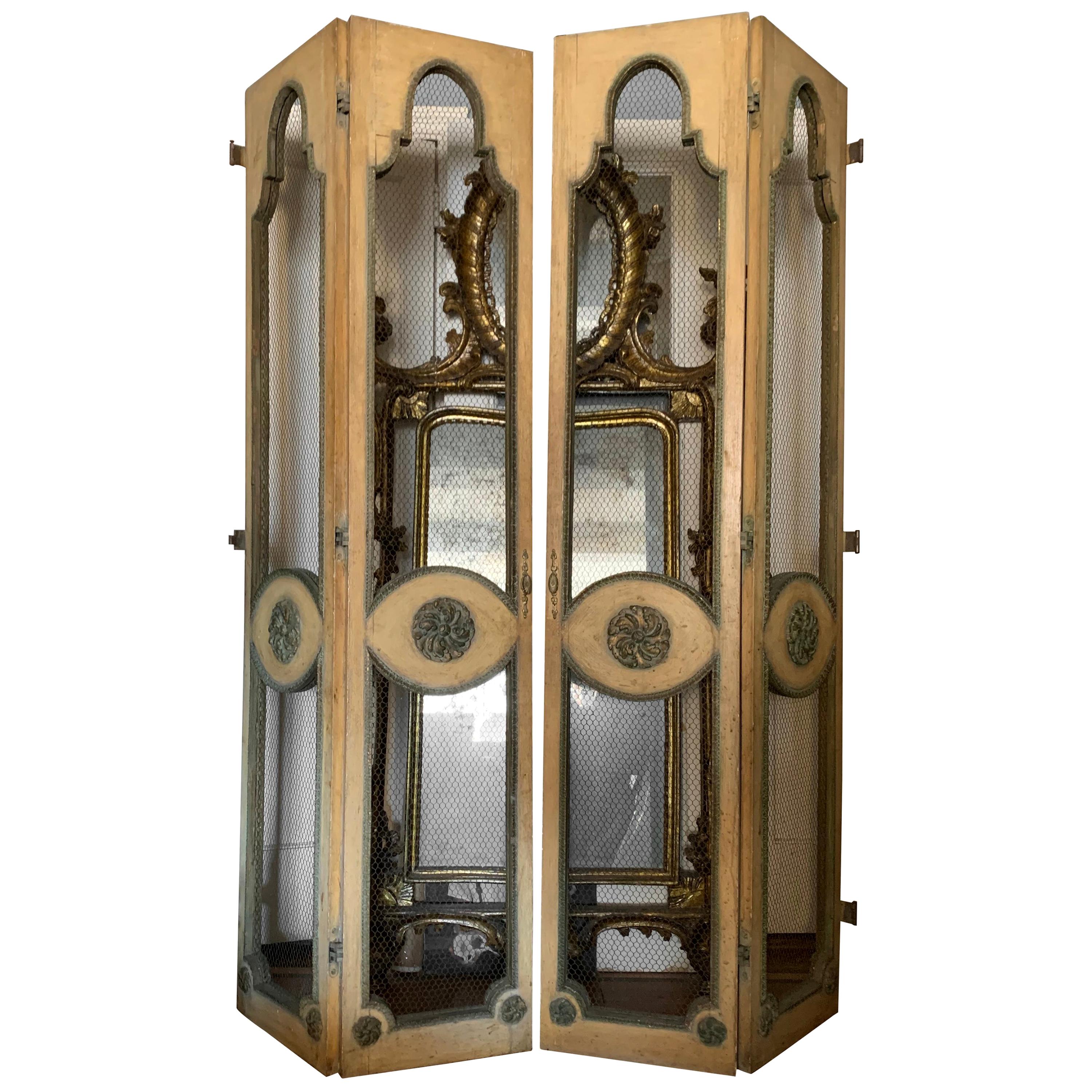Venetian screen room divider. Tall pair arched top double-panel painted and gilt carved wood doors with wire insets finished on both sides with original hardware and hinges, American, circa 1920s.
Dimensions: 60