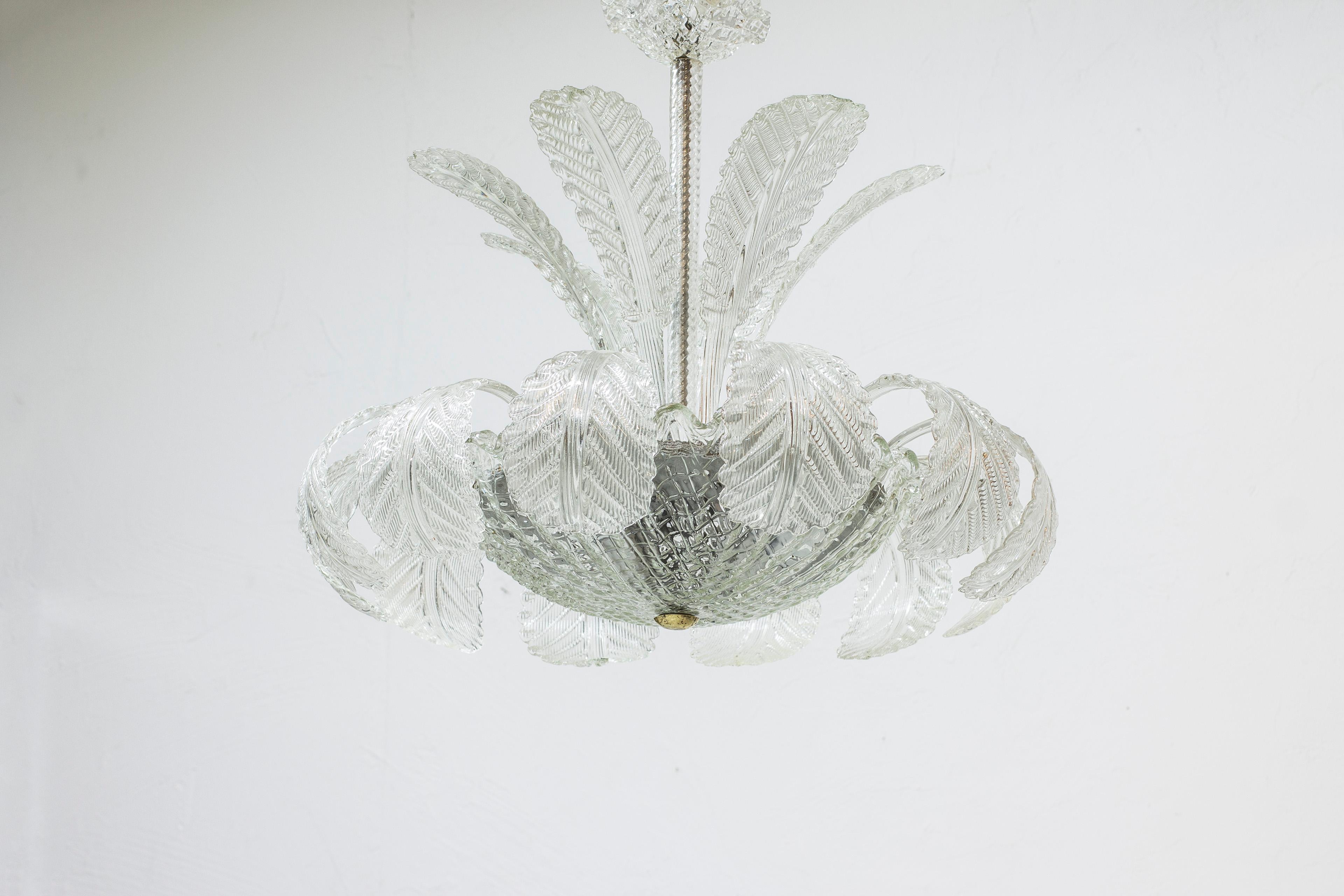 Chandelier designed by Fritz Kurz. Produced by Orrefors in Sweden in the 1940s. Made from cast blown clear glass. Venetian style with sixteen leaves, glass bowl and ceiling mount in glass. Very good vintage condition with few signs of age related