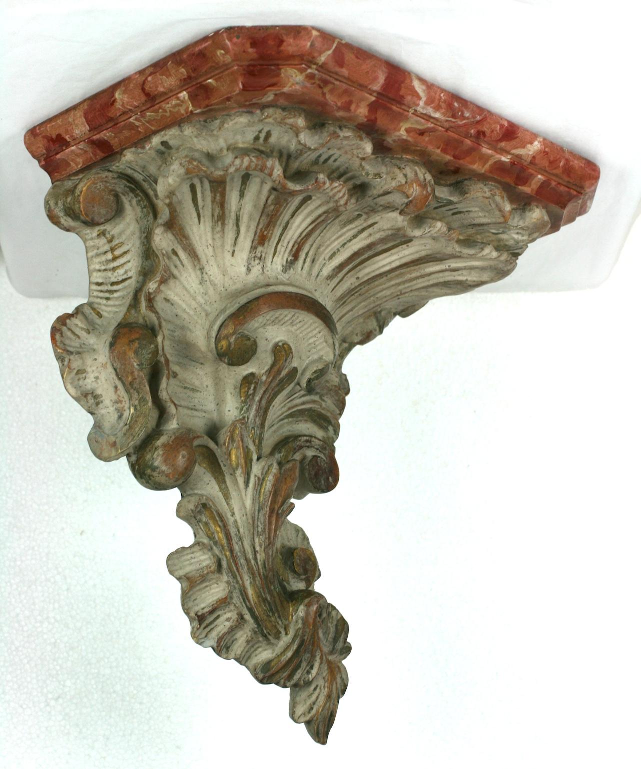 Venetian style faux marble bracket of cast plaster, beautifully paint decorated with gilt highlights on ivory. The top is painted in a faux marble technique for a rosy marble effect,
1930s, European.