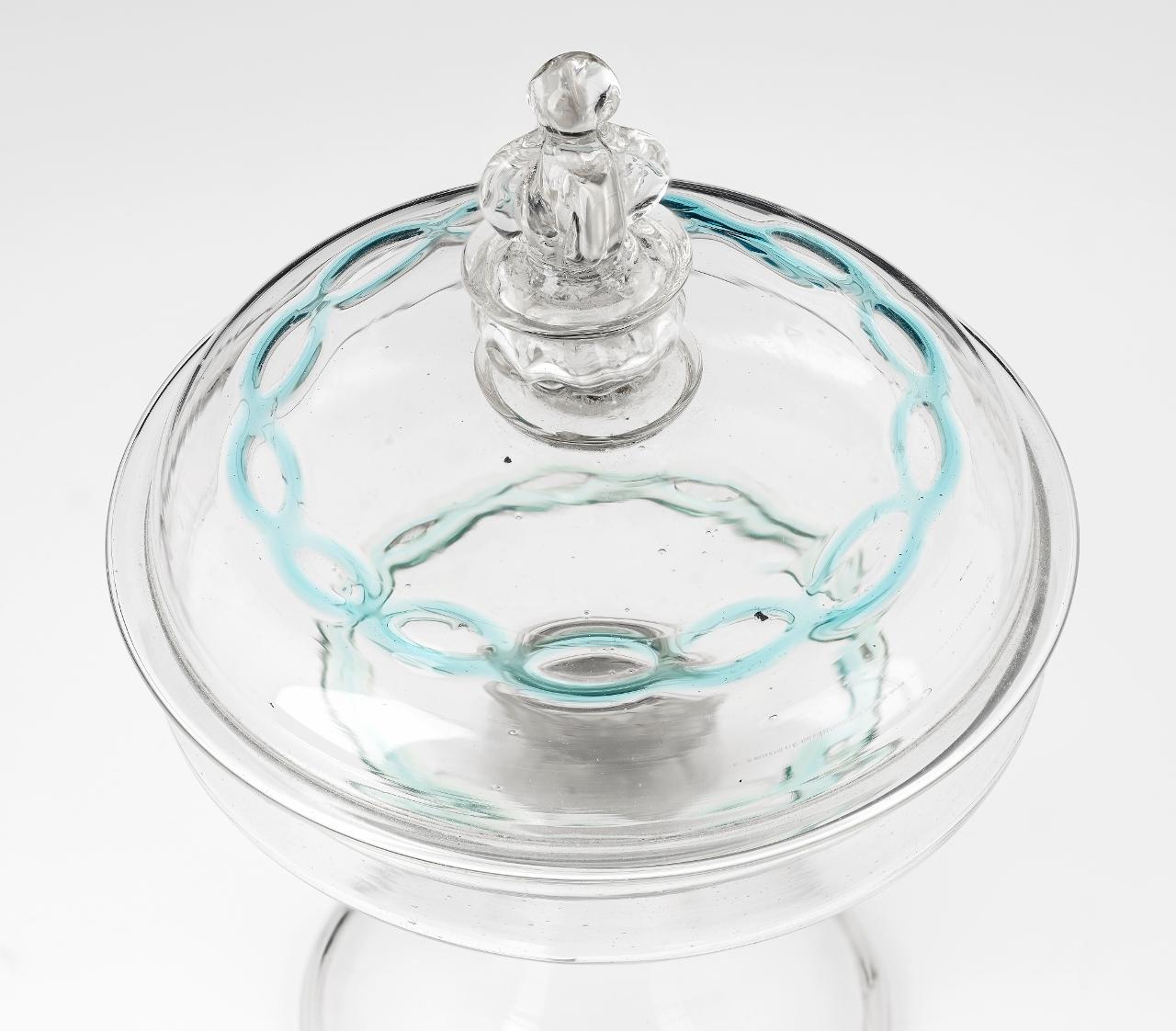 Rare Venetian tazza 17th century with domed cover.

An extremely rare antique Venetian glass footed wine cup or tazza with a domed cover; second half of the 17th century; made with cristallo glass decorated with blue intertwined trailing around