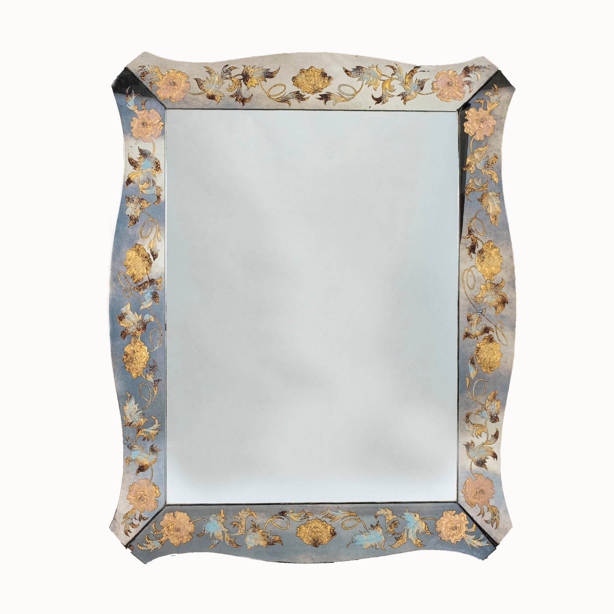 A large 1940s Venetian verre églomisé mirror with floral and vining detail. Soft blues and gold in coloring.