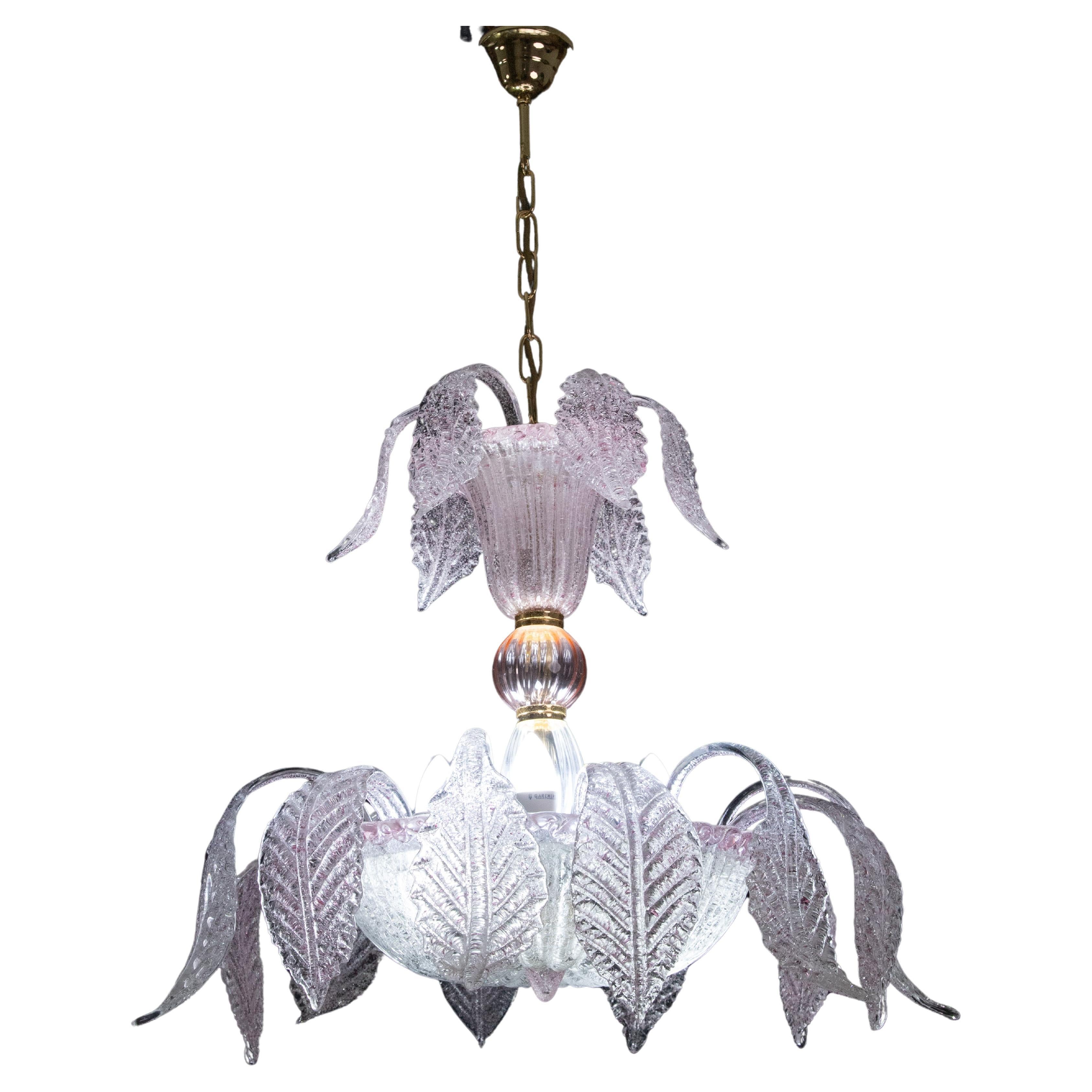 Venetian murano chandelier with high leaves and low leaves.

The high leaves are smaller, the low leaves larger, all handcrafted and different from each other, a beautiful pink cup at the bottom.

The mounted chandelier with chain measures 90