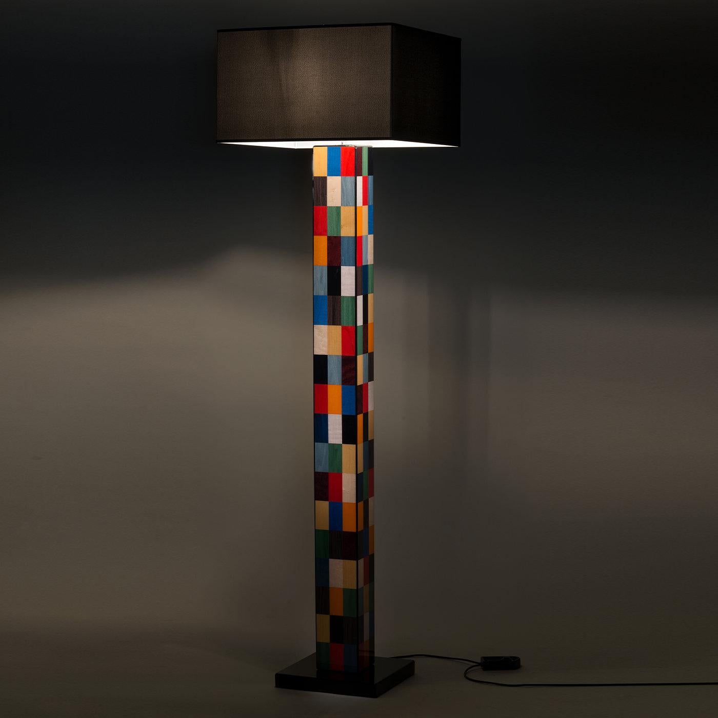 Distinguished by modern art-inspired motifs, this exquisite floor lamp will make a bold and stately addition to a contemporary or eclectic decor. Masterfully handcrafted of wood, it features a geometric stem rising from a square black-lacquered