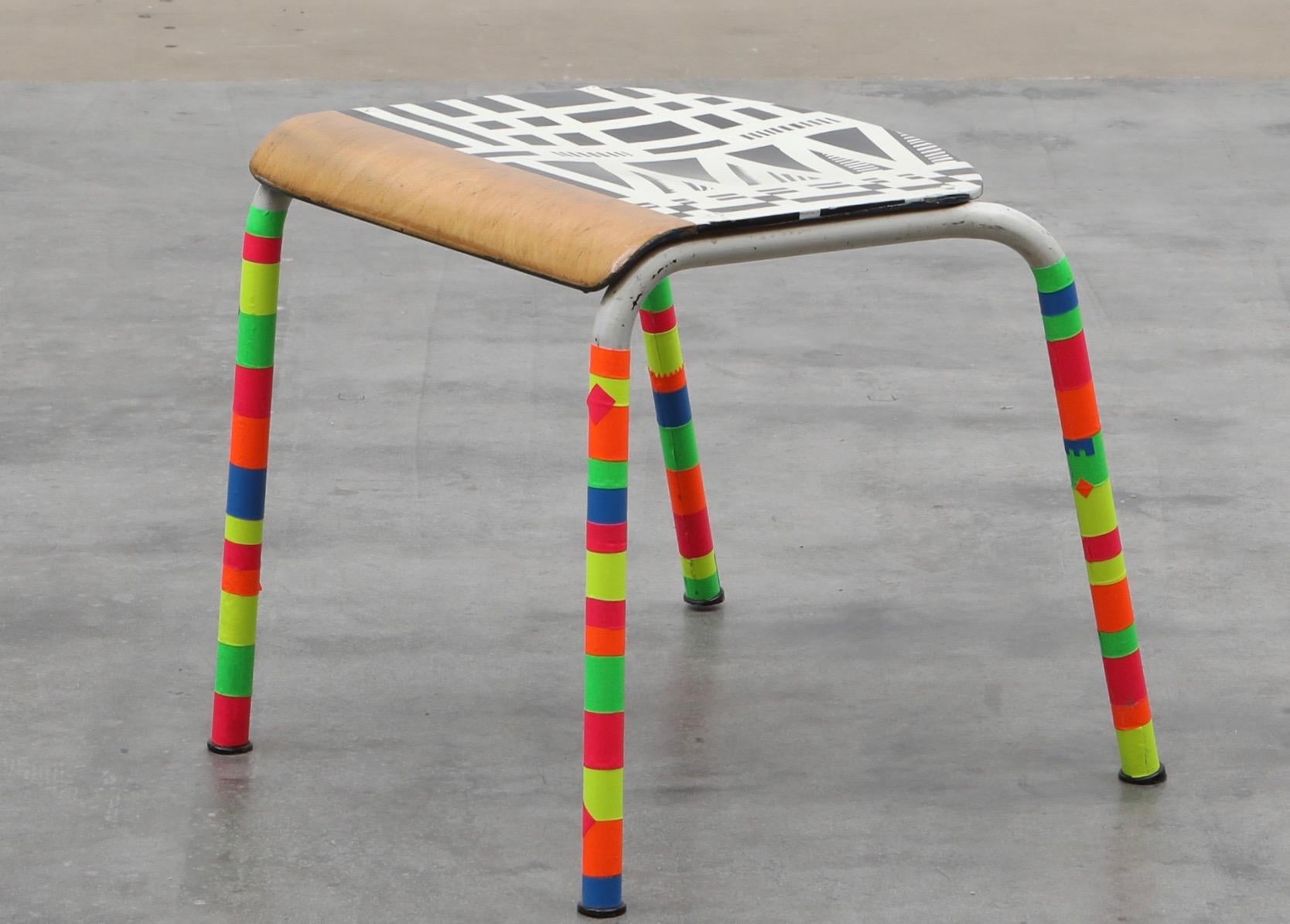 Redesigned German Bundeswehr chair. Backrest cut off, seat spray-painted black & white in the manner of Grignani and Vasarelly, with a thought of Jorge Pardo and Tobias Rehberger Zeitgeist works.
Legs taped in bright neon color tape. Functional,