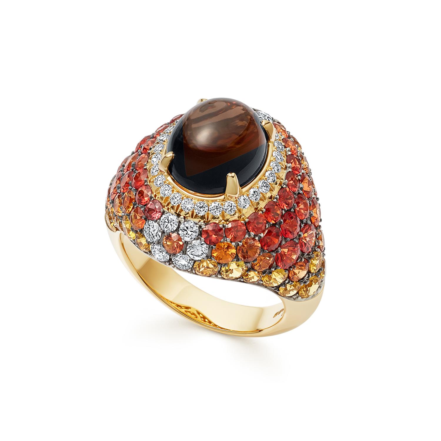 In this cocktail ring, a delicate circle of brilliant cut diamonds encompass a mesmerising dark smokey quartz cabochon, expertly contrasting against the harmonious mix of vibrant yellow and orange sapphires.

Details
- 18 karat Yellow Gold
- 5.79