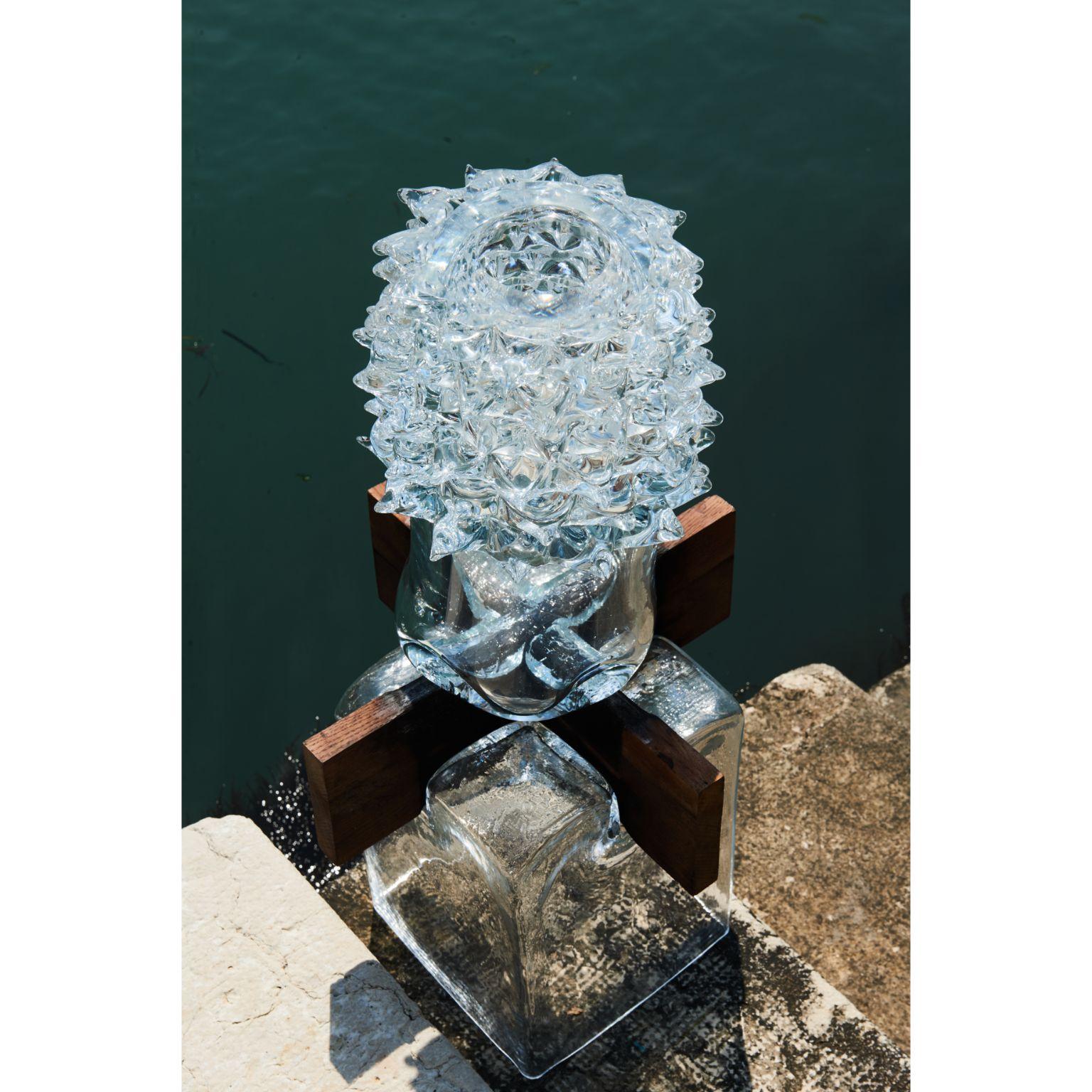 Venice Collection Vase by Alexey Drozhdin
Dimensions: D 25 x W 25 x H 72 cm. 
Materials: glass, oak shape.

A young designer and artist Alexey Drozhdin creates extraordinary decorative glass objects. the designer became a finalist of the