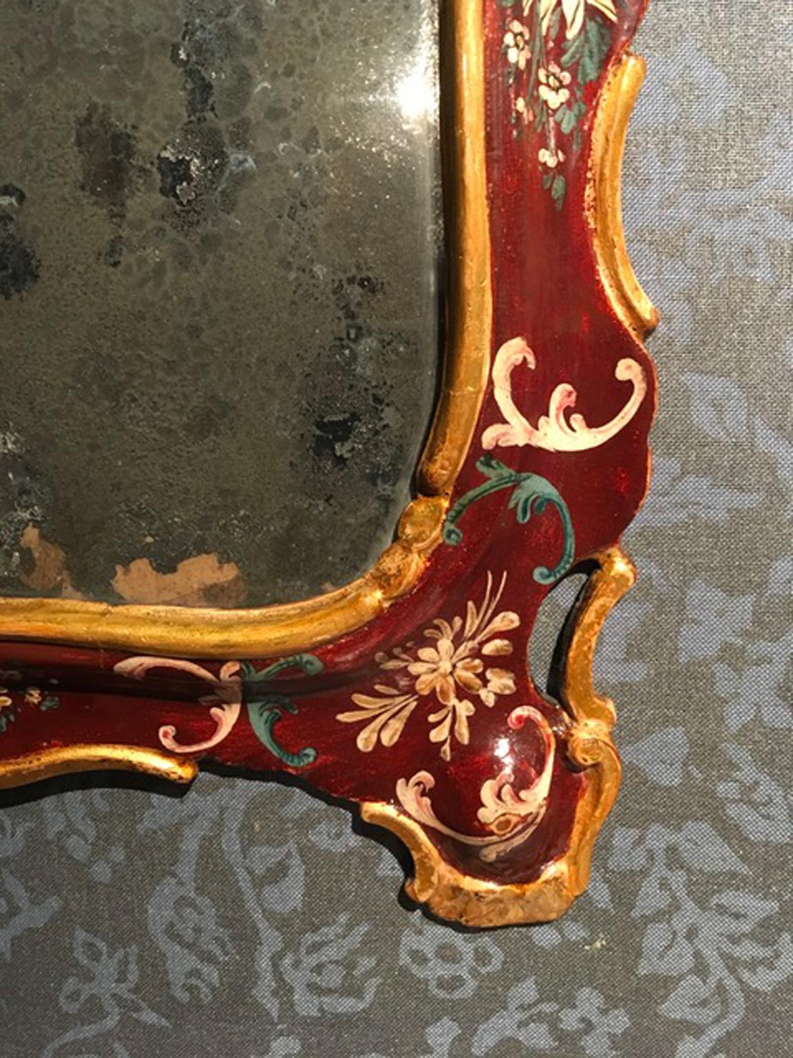 This is a very fine handmade baroque wooden mirror, with the original mercury glass. The wooden frame is hand painted with elegant flowers drawings and a golden border. A perfect piece to furnish an elegant entry hall.

A very decorative piece and a