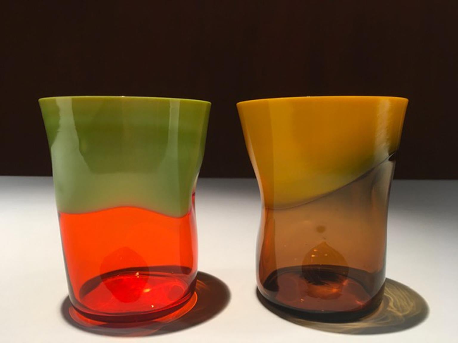 This is an original Murano, Venice handmade production. This pair is composed by two pieces one in orange and green, the other one in amber and yellow. The abstract form it is their peculiarity, no one it is ugual to the other. This is the