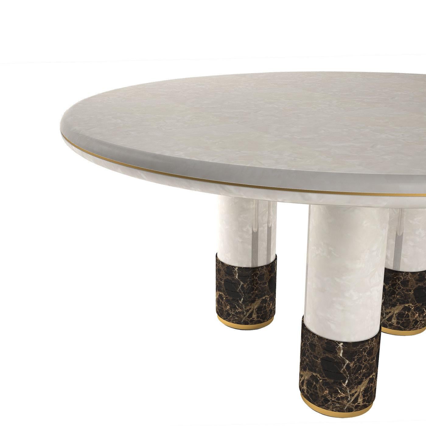 Bold and stately in its absolutely refined and charming choice of finishes and first-rate materials, this stunning dining table will create a plush and warm focal point in a contemporary interior. Fashioned of wood, it rests on three sturdy