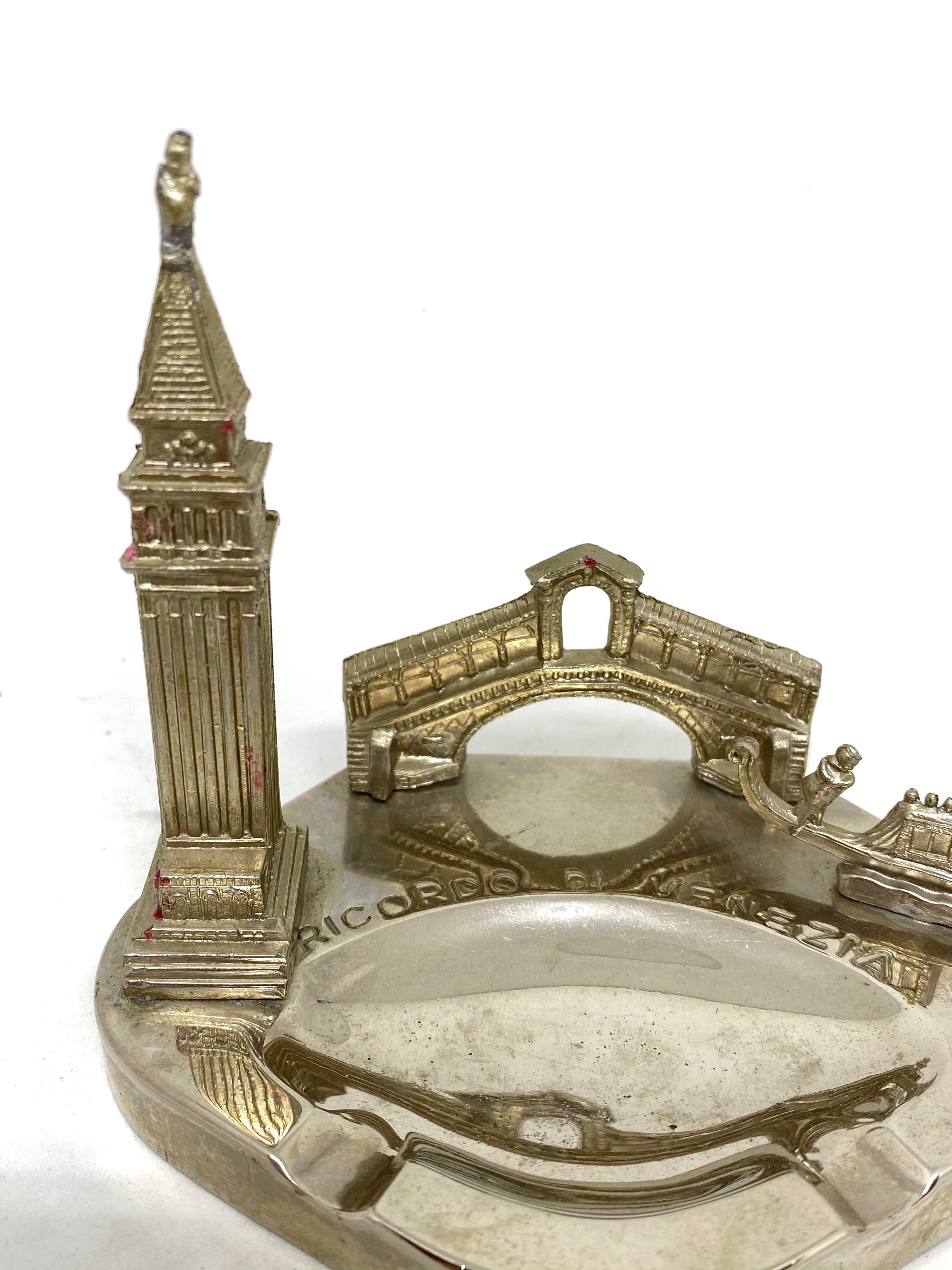 A 1950s souvenir building architectural model ashtray. Some wear with a nice patina, but this is old-age. Made of metal. A beautiful nice item to use or just a display item in your collections of souvenirs from around the world.

 