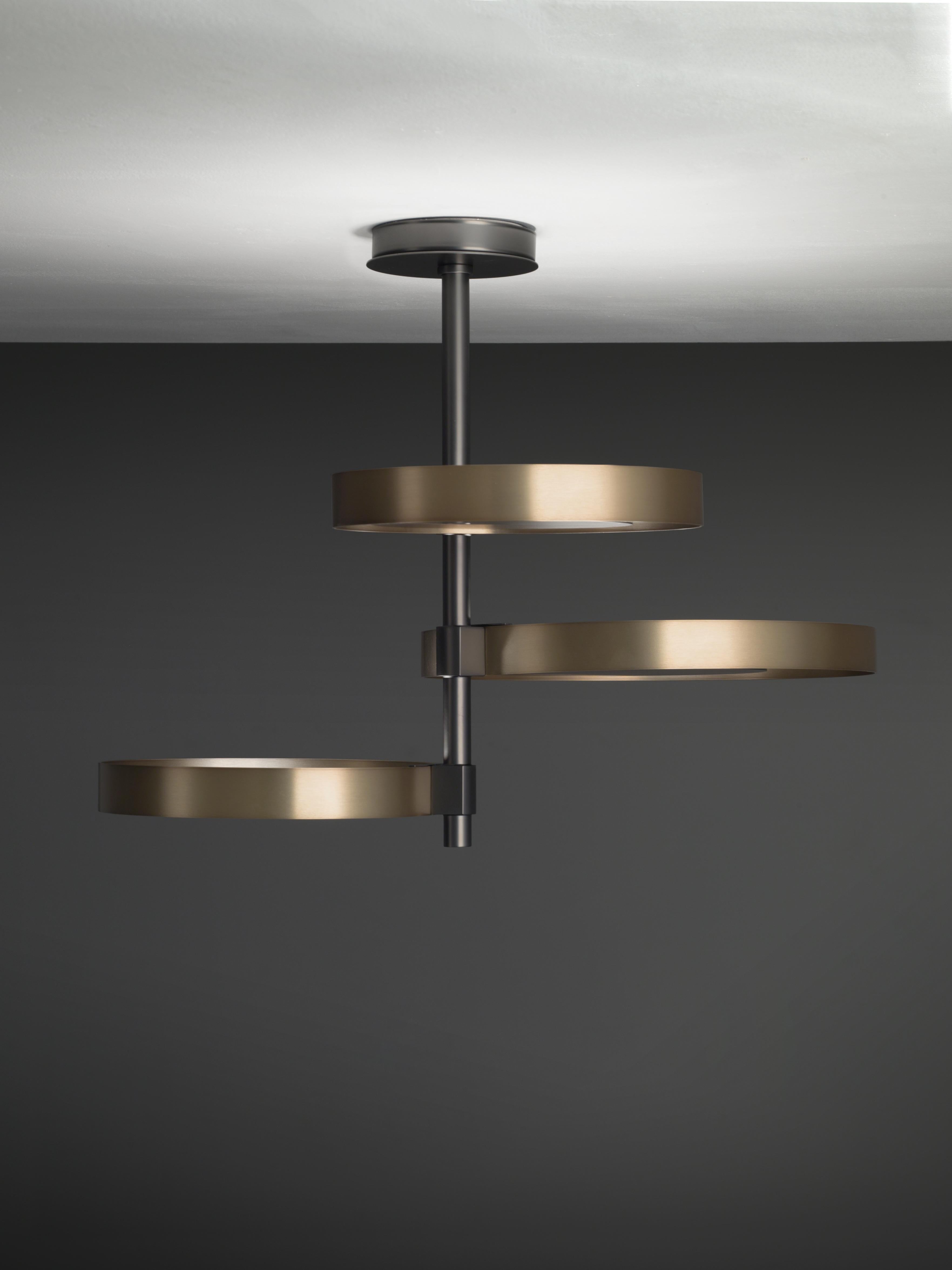 Ceiling lamp with indirect light. Light burnished brass rings and matte black nickel structure.

Location: Interior
Light source: 3 × 17W 1500lm 2700°K CRI90
Voltage: 110 - 120 V / 220 - 240 V
Frequency: 50 - 60 Hz
Dimmable: Yes
Mounting: