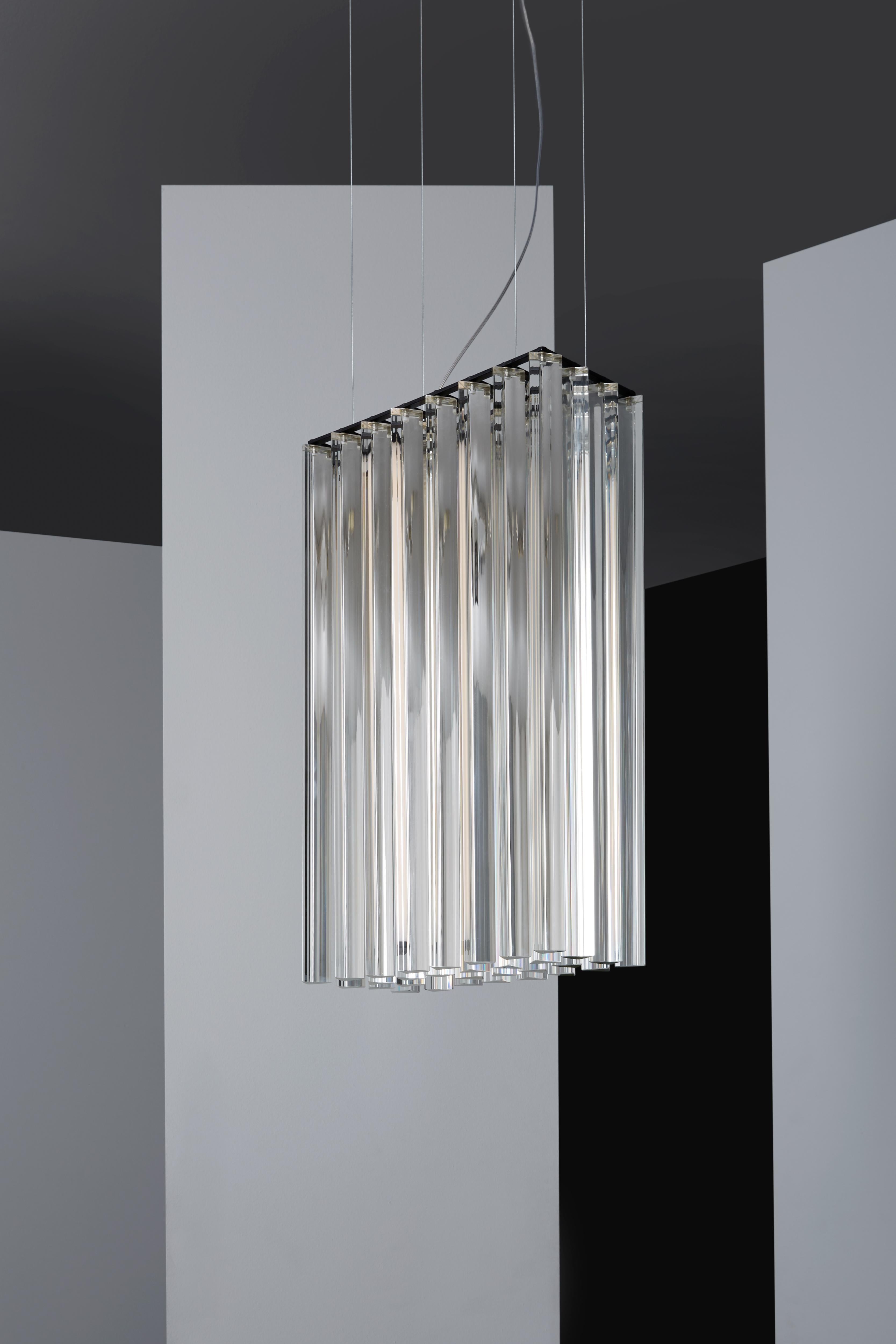 Suspended lamp with diffused light. Black metal structure with steel cables, composed of crystal triangular trihedrons. Strip LED inside the central cylindrical body.
 
Location: Interior
Light source: 1 × 17W LED 2225lm 2700°K CRI90
Voltage: