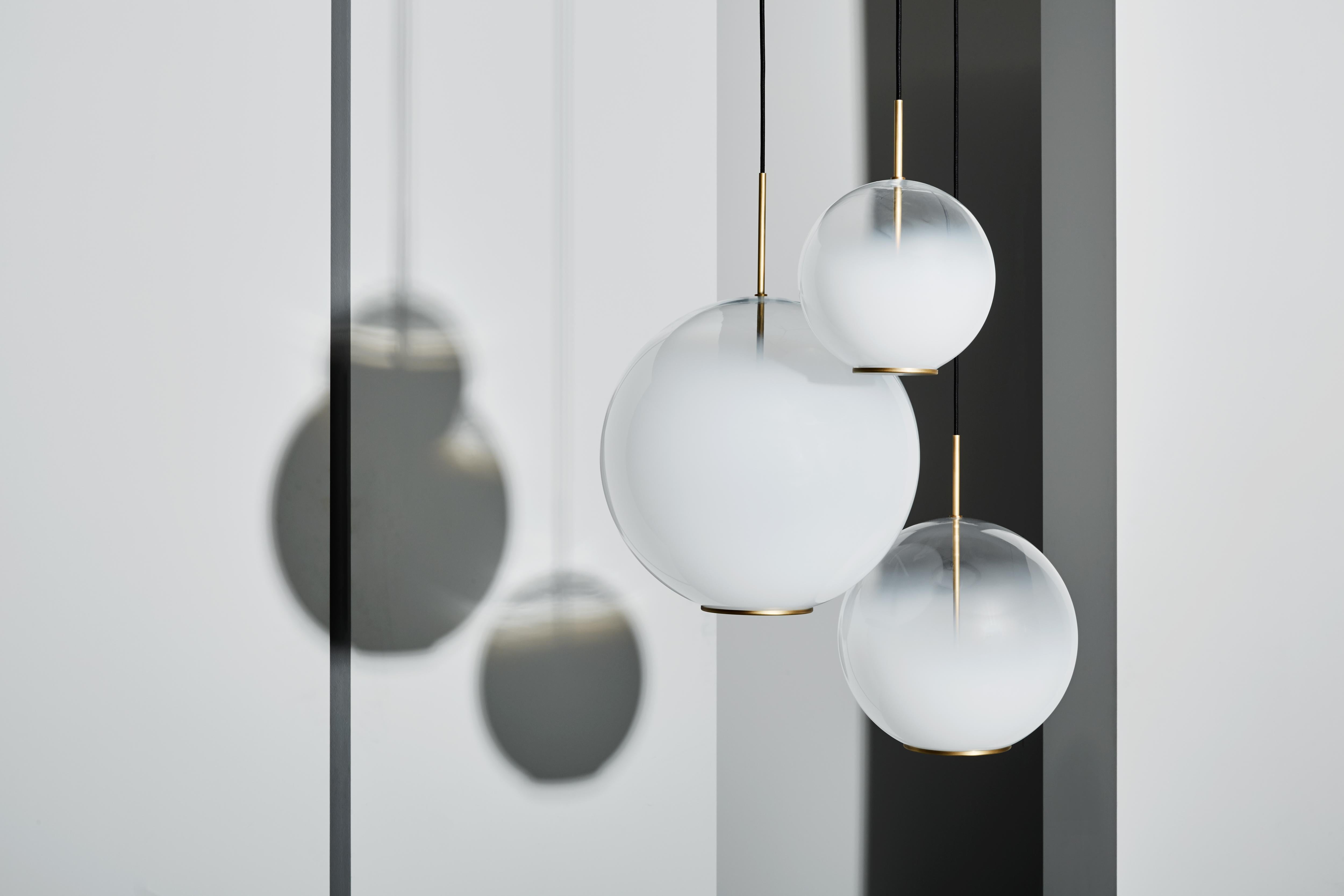 Suspended lamp with diffused light. Natural burnished brass structure and white blending blown glass diffuser.

Also available in additional sizes.

Location: Interior
Light Source: 1×5W LED 10V 676lm 2700°K CRI80-Dimmable 1-10V
Voltage: 110 -