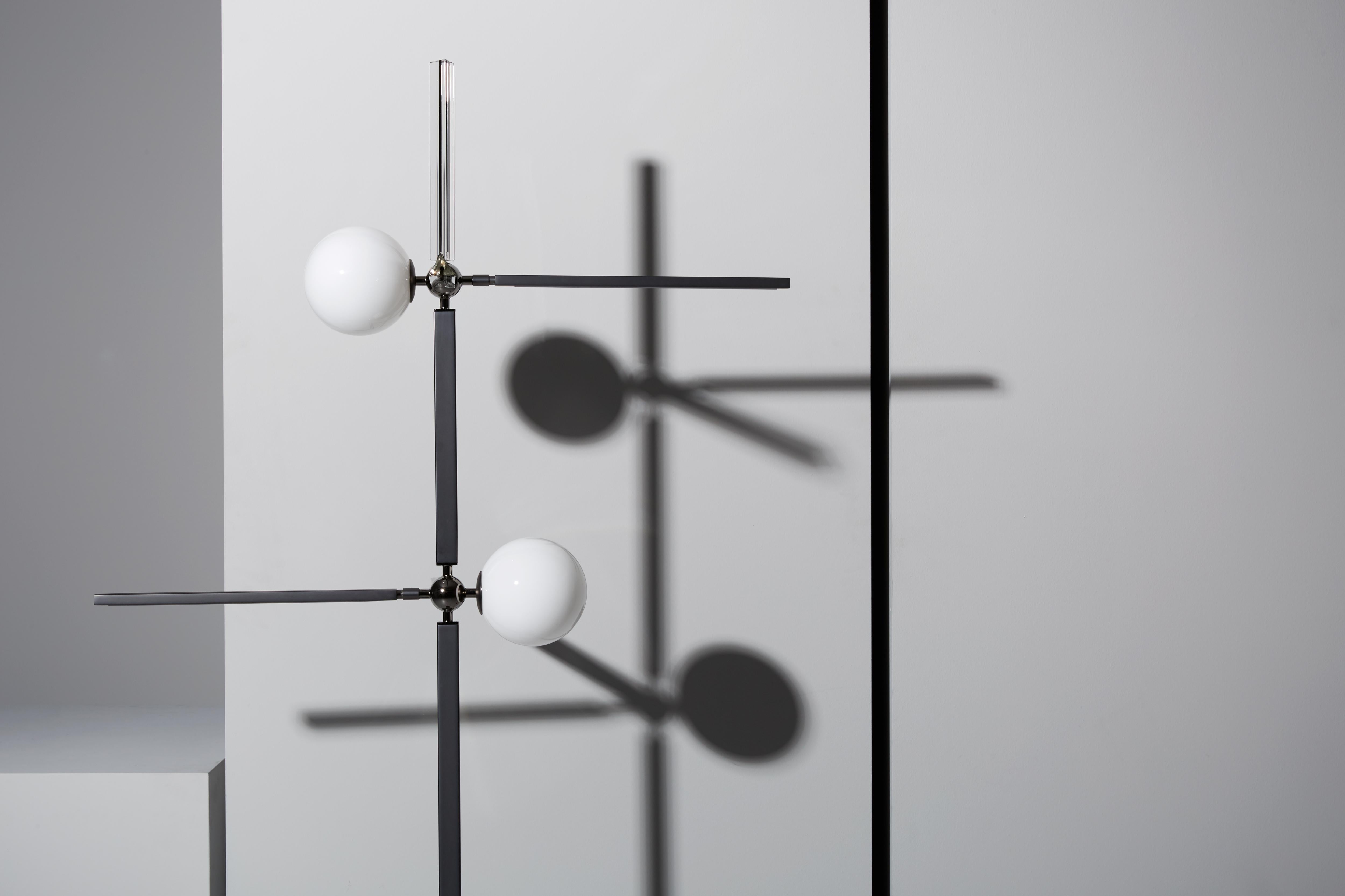 Floor lamp with diffused light. Matte black nickel structure with polished black nickel spheres. Crystal, amber and smoke grey Murano blown glass trihedrons. White Murano blown glass diffusers.
Specifications:
Function: Floor
Location:
