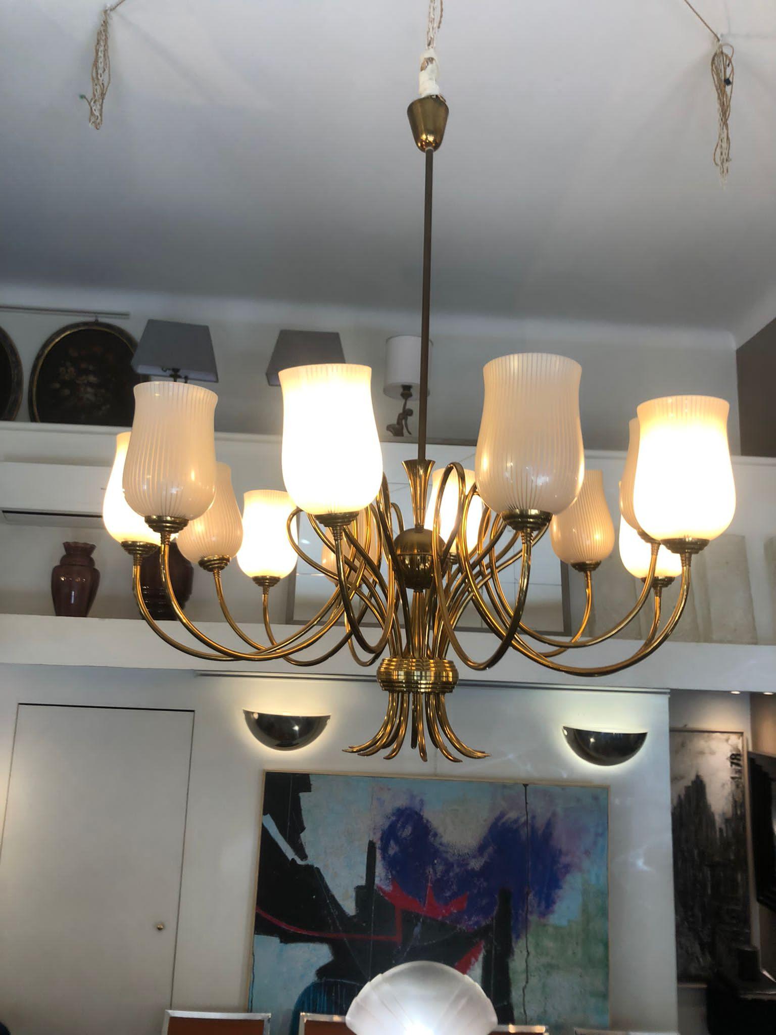 Venini 1940s brass arms and blown glass lampshades chandelier, attributed.
A chandelier with brass arms and 12 blown glass lamp shades for 12 lights.
Restored in conservative way, two lampshades were broken and they have been replaced with new