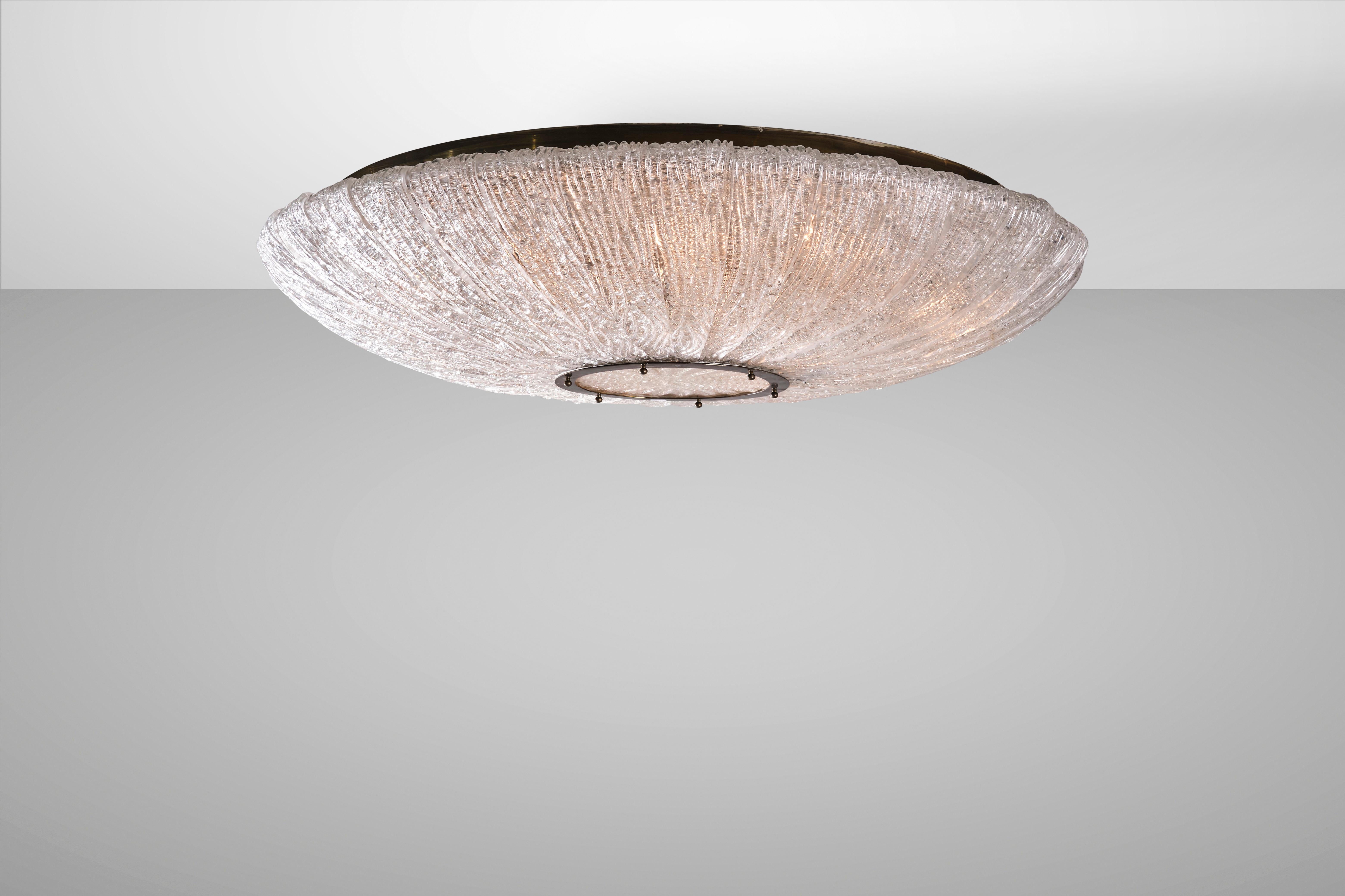 Elegant and timeless, Murano glass ceiling lamps are varied and diverse but each carries with it the aura of the wisdom of the lagoon's master glassmakers. This ceiling light from the 1940s is made of metal and brass with Corteccia (bark) glass