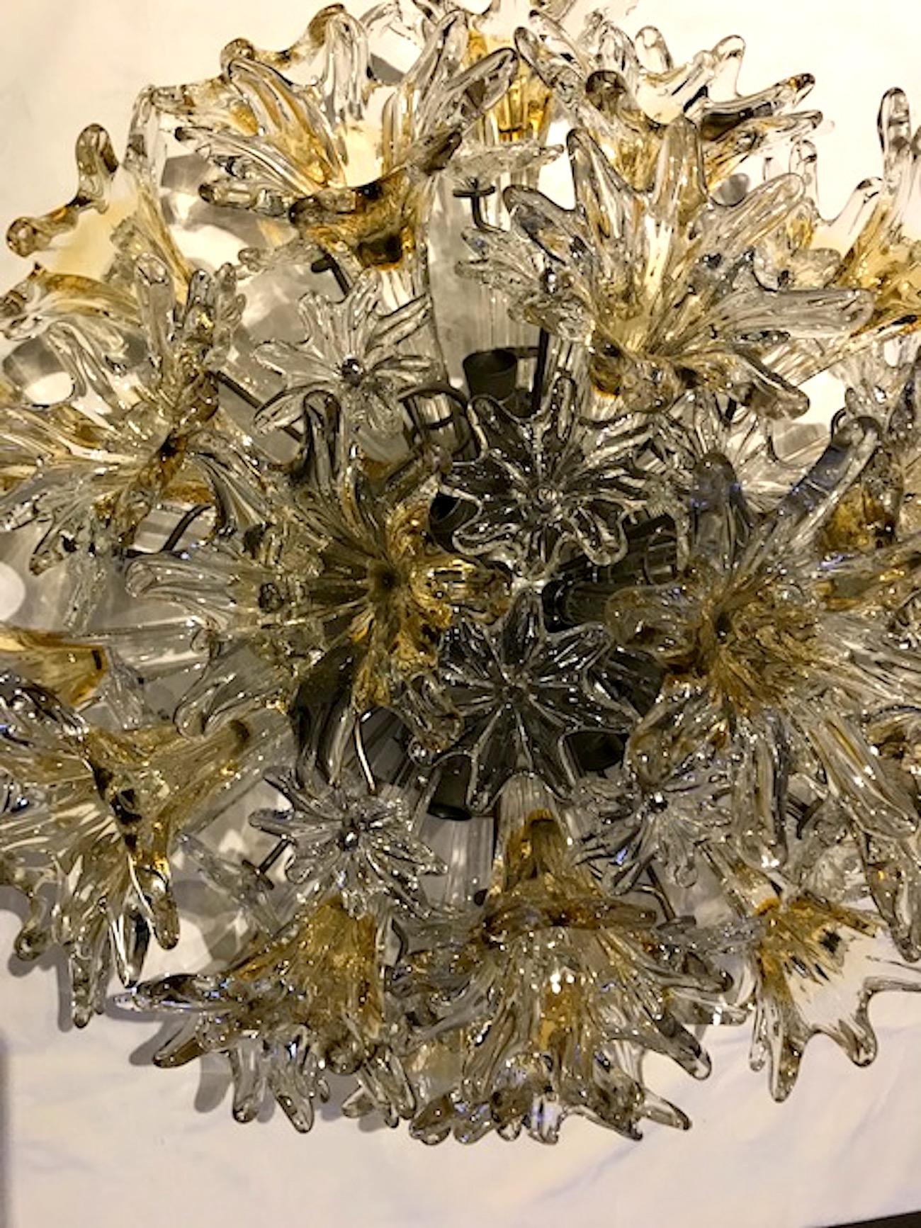 Deigned by Toni Zuccheri for Venini is this Esprit ceiling mount light. Venini describes the model “Esprit” as an explosion of flowers and stars in hand blown, handcrafted glass. Designed to illuminate, shine, sparkle and excite, “Esprit” is ideal