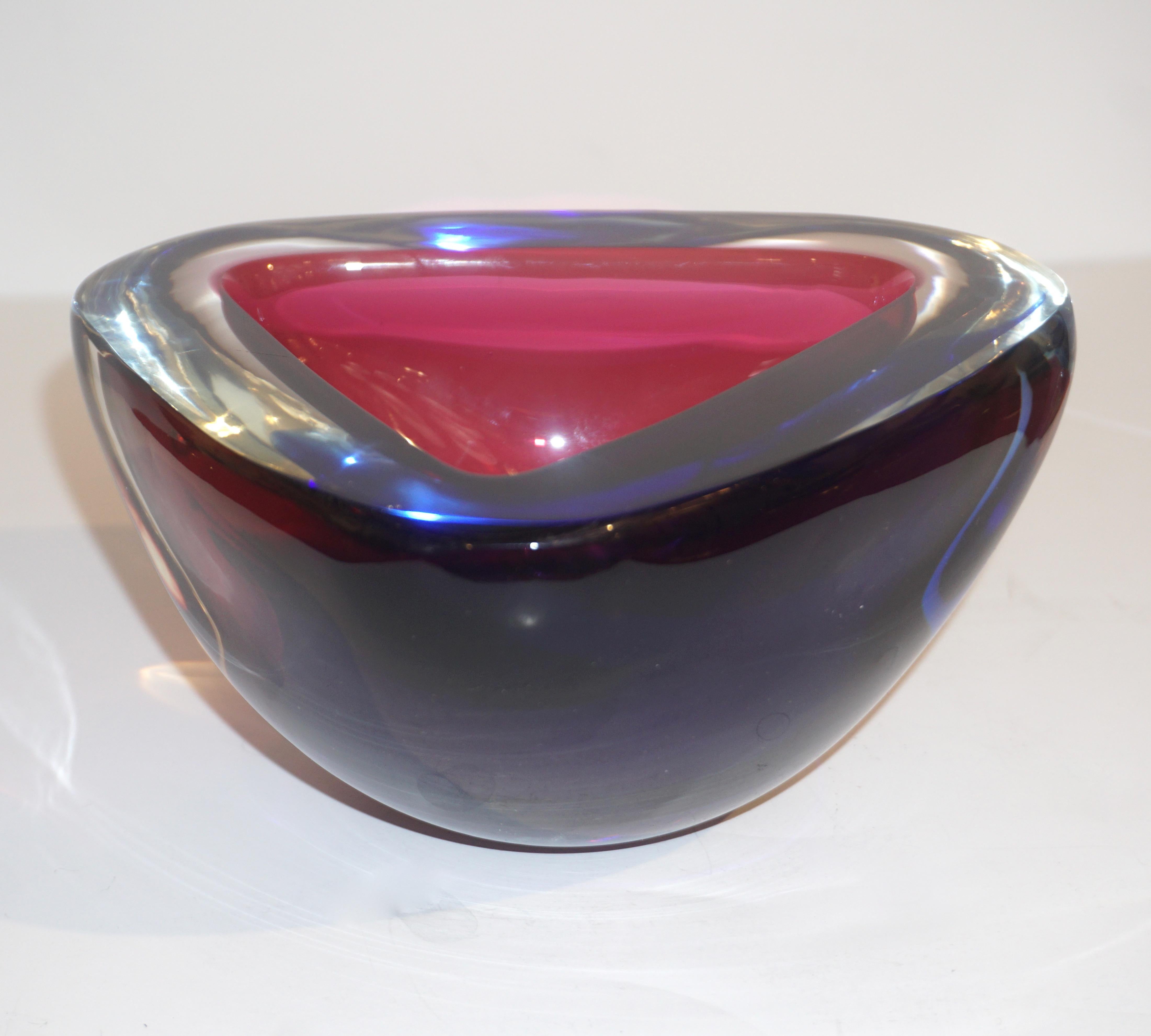 Vintage organic modern 1970s blown Murano glass bowl or catchall dish in magenta red and deep blue, signed by Venini, elegantly decorated in patch colors that catch the light and enhanced the shape with flat cut polished top. Also, available in two