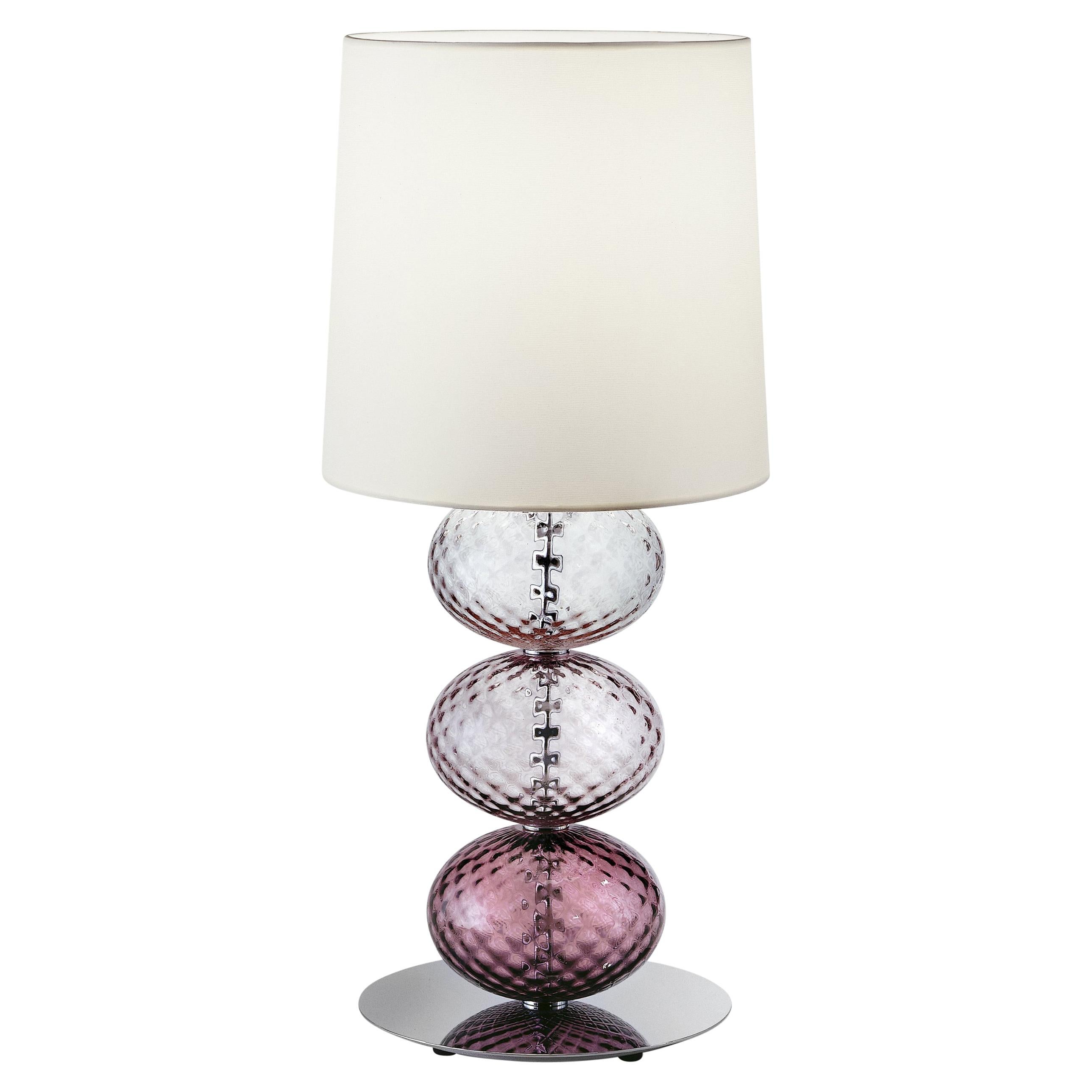 Abat-Jour Bedside table lamp, designed and manufactured by Venini, features elliptical hand-blown elements crafted using the “balloton” technique. 

Dimensions: Ø 33 cm, H 60 cm.