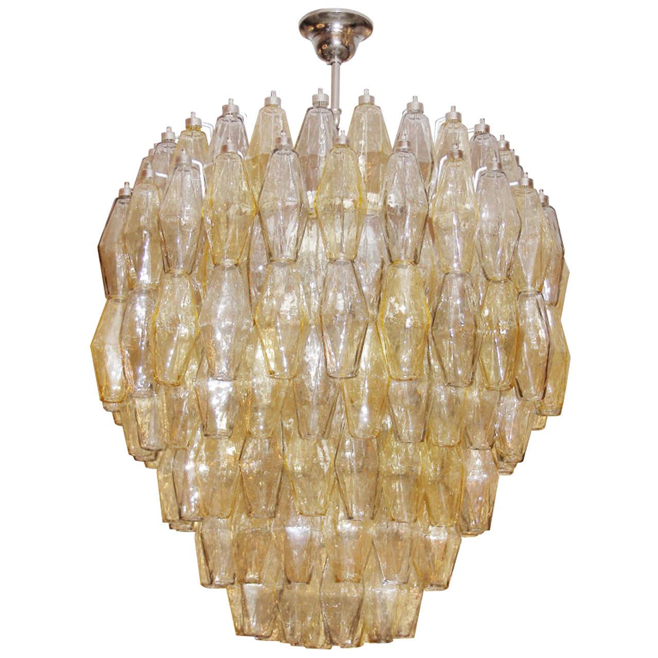 An exquisite Venini amber and pale gray tiered polyhedral glass chandelier with polished nickel hardware.