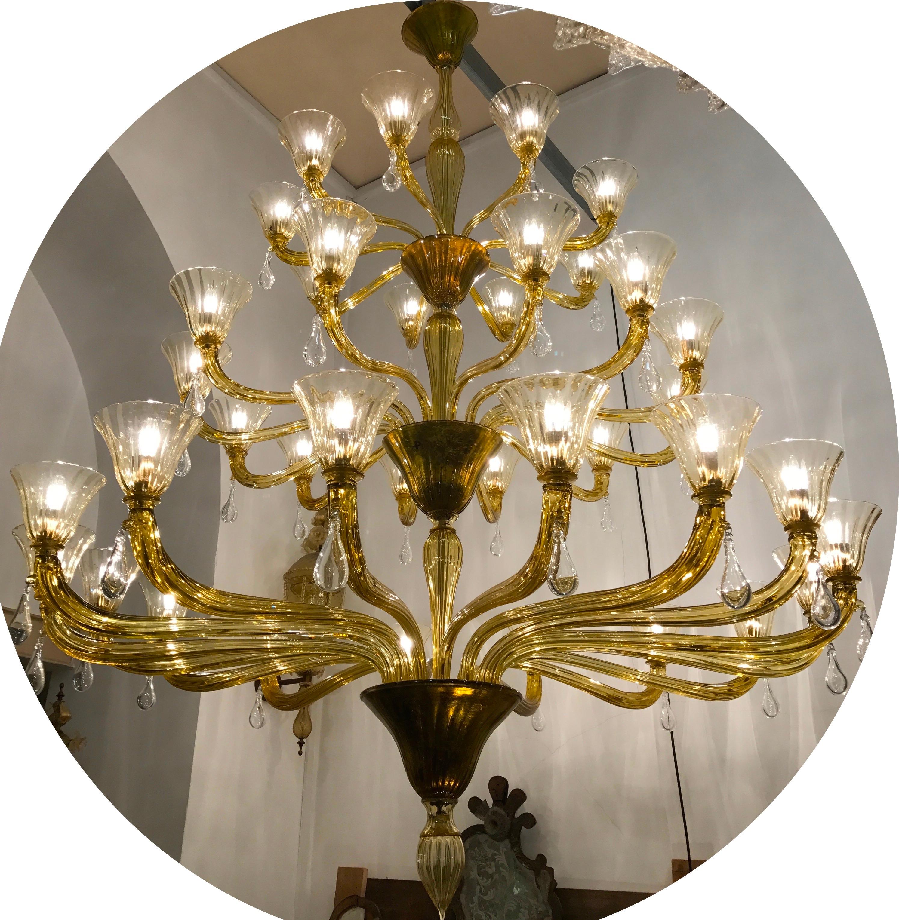 This magnificent chandelier on three levels features 37 arms with glass drops.
Cups with gold inserts. Original Venini stamps.
Cleaned and re-wired, in full working order and ready to use. In excellent vintage condition. All original glasses in