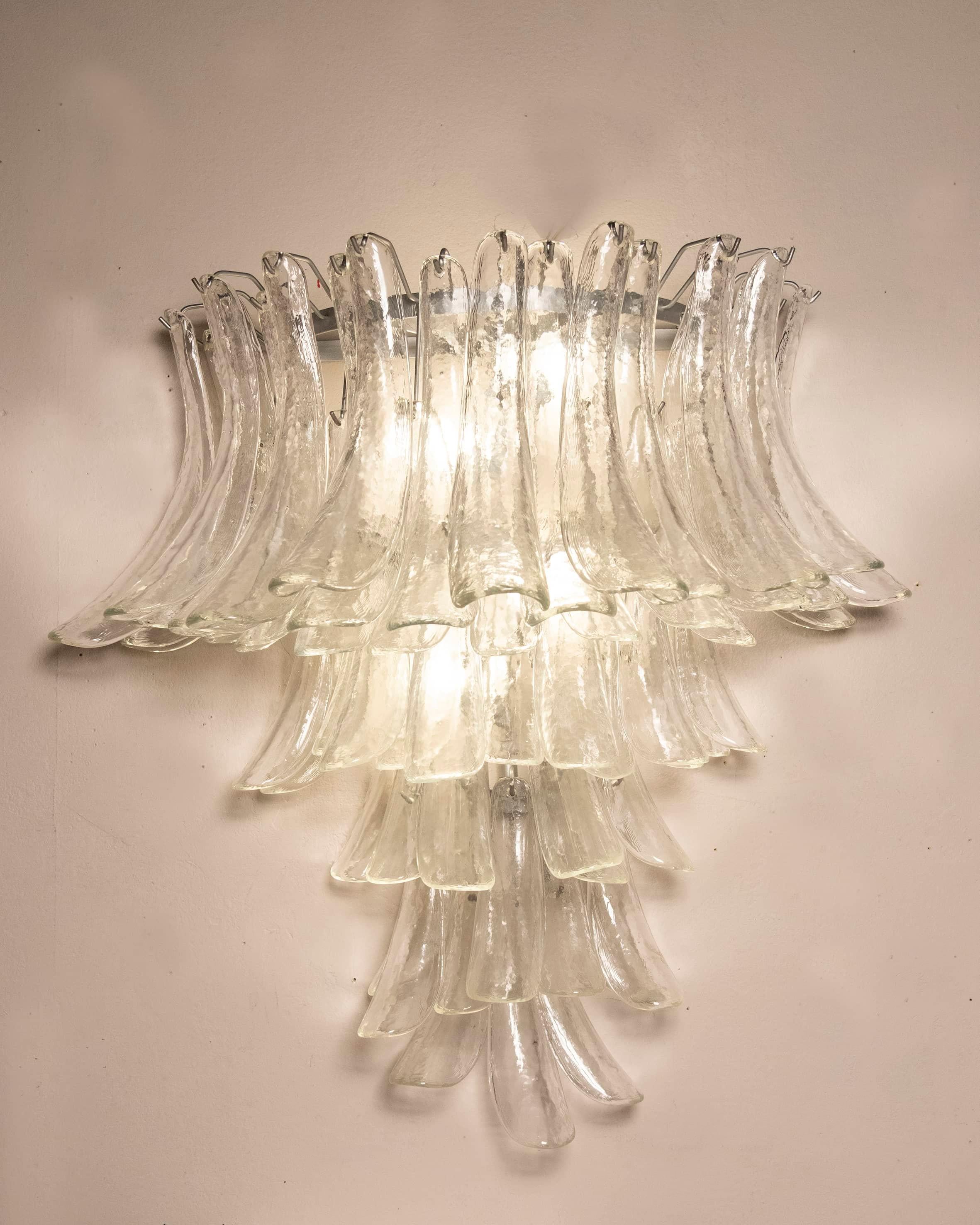 Wall sconce / wall lamp formed by several glass petal, particular for their thickness, by Venini. 
Object from the 1970s in perfect condition. 
Measurements W95 D 50 H 90 CM.
Also available a wall sconce with the same characteristics but smaller.