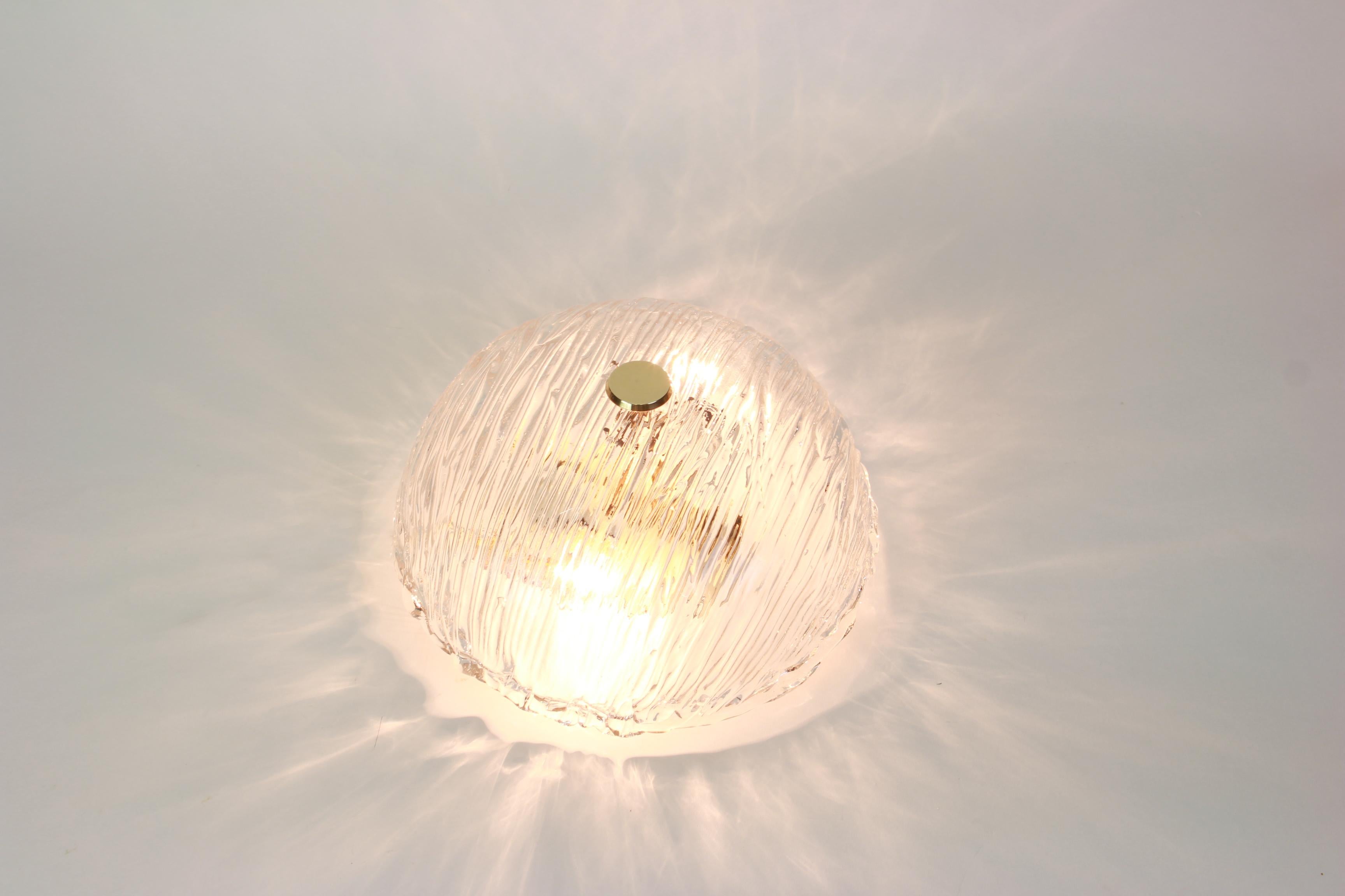 Venini ceiling lights attributed to Carlo Scarpa for Venini, 1950s.
Wonderful light effect.
The heavily textured and slightly iridescent glass dome is held in place by a brass screw.
Good condition.
Each flush mount needs four E14 Small bulbs