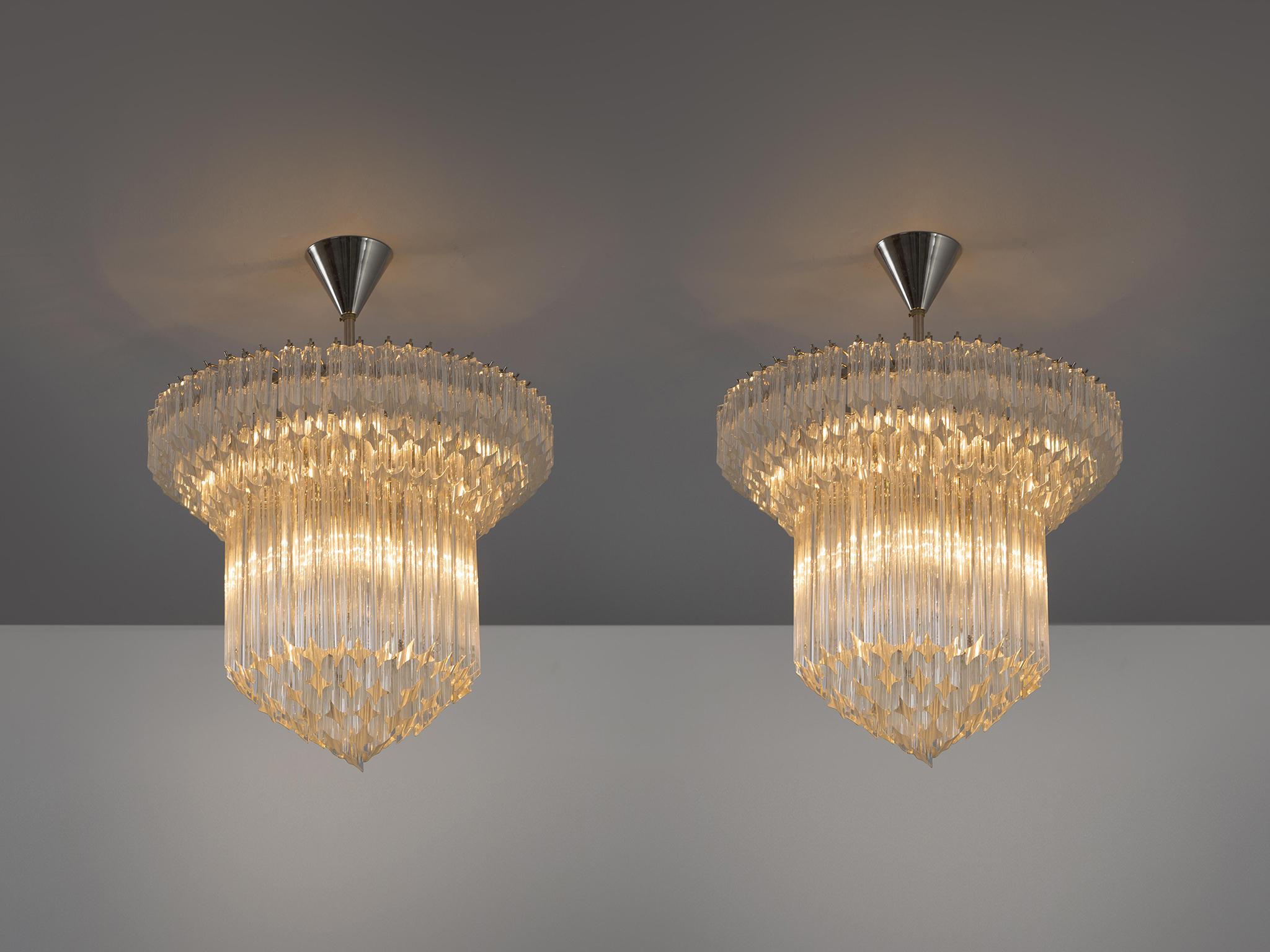 Venini, chandeliers, glass, polished nickel, Italy, 1970s.

Very elegant Venini chandeliers in glass and nickel. These high quality original 1970s productions still show the excellent quality they have been made with during that time. Coming from an