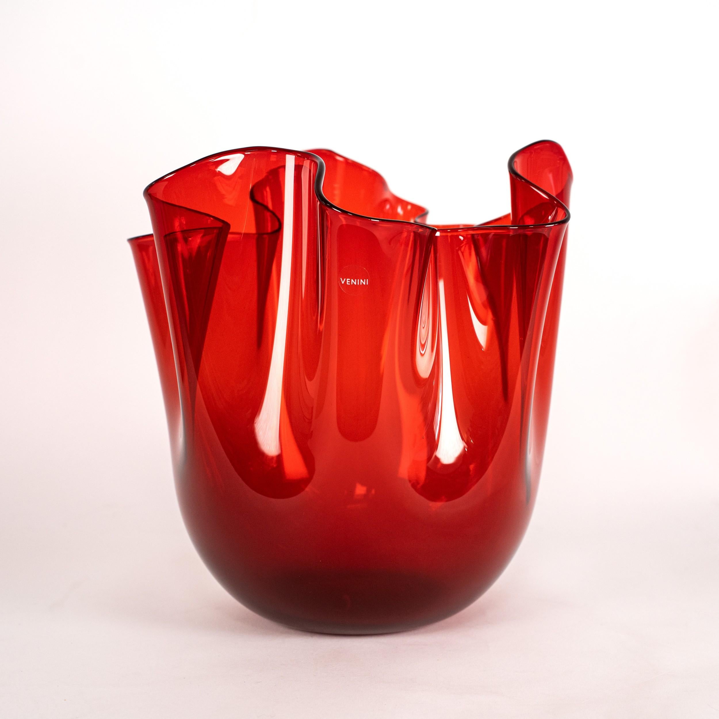 Iconic Venini Fazzoletto vase, model 700.00, in Red glass, diamond-engraved Venini 2005 with box and paperwork.

Hand-blown and shaped free-hand using the traditional mano volante technique, creating the signature undulating rim that defines the