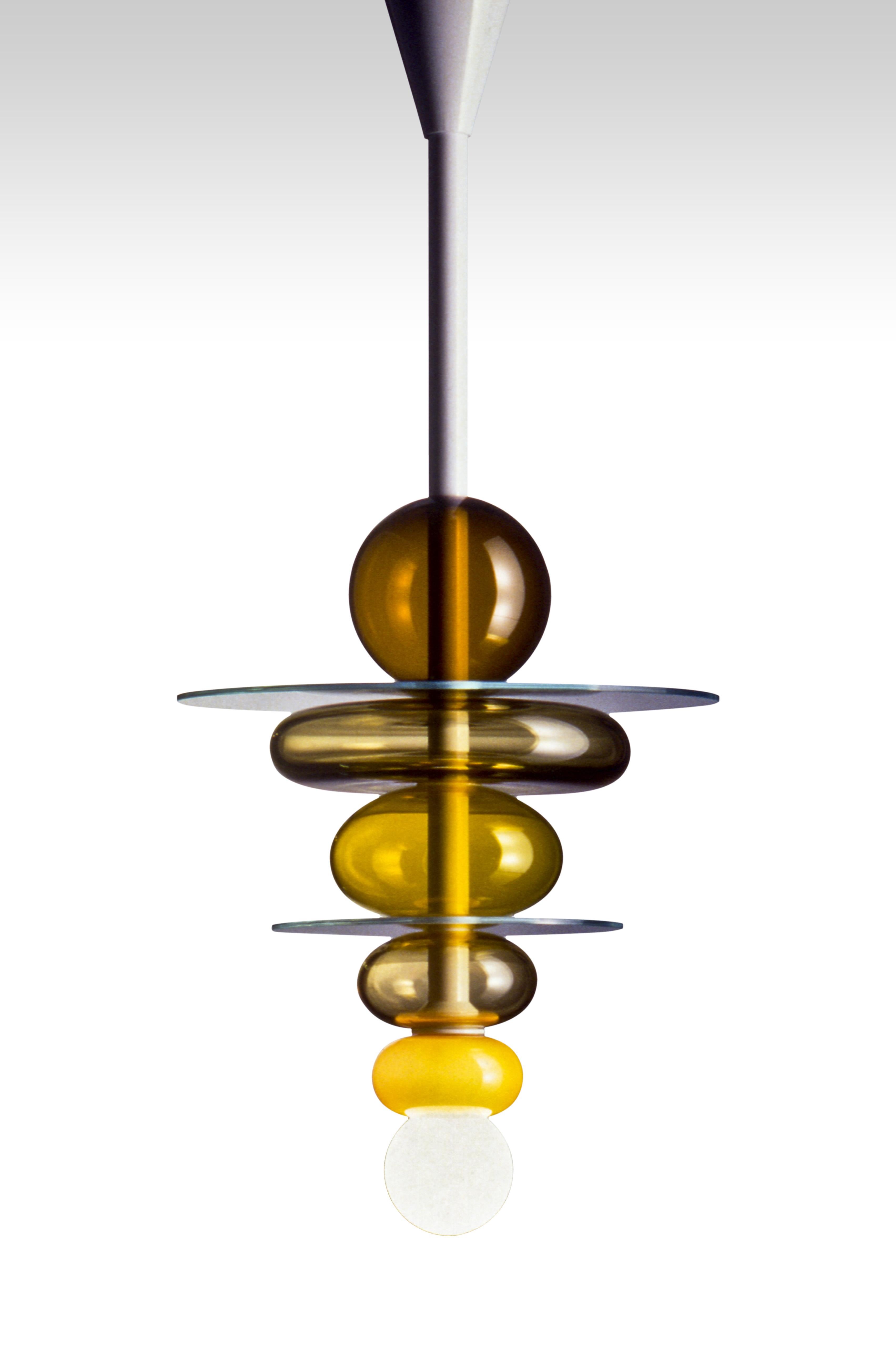 Firenze suspension lamp, designed by Ettore Sottsass and manufactured by Venini, features handmade blown glass colored elements and crystal color discs. Numbered edition. Indoor use only.

Dimensions: Ø 40 cm, H 80 cm.
