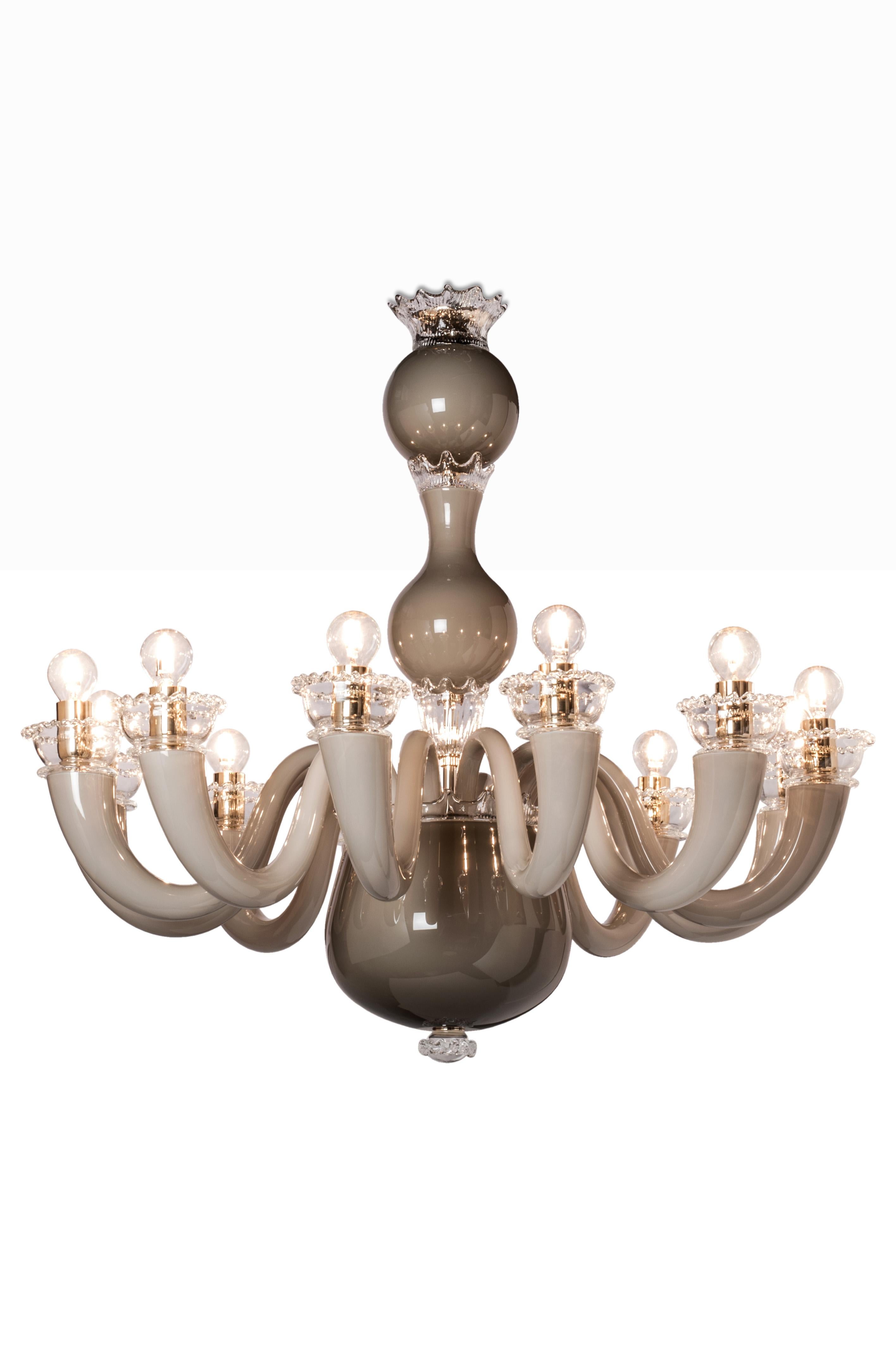 Glass chandelier with gold-plated metal finishes and chain. An understated and elegant chandelier option particularly suitable to an entrance or living room environment. Also available in various sizes and colors. 

Light source: 12 x max 60 W E