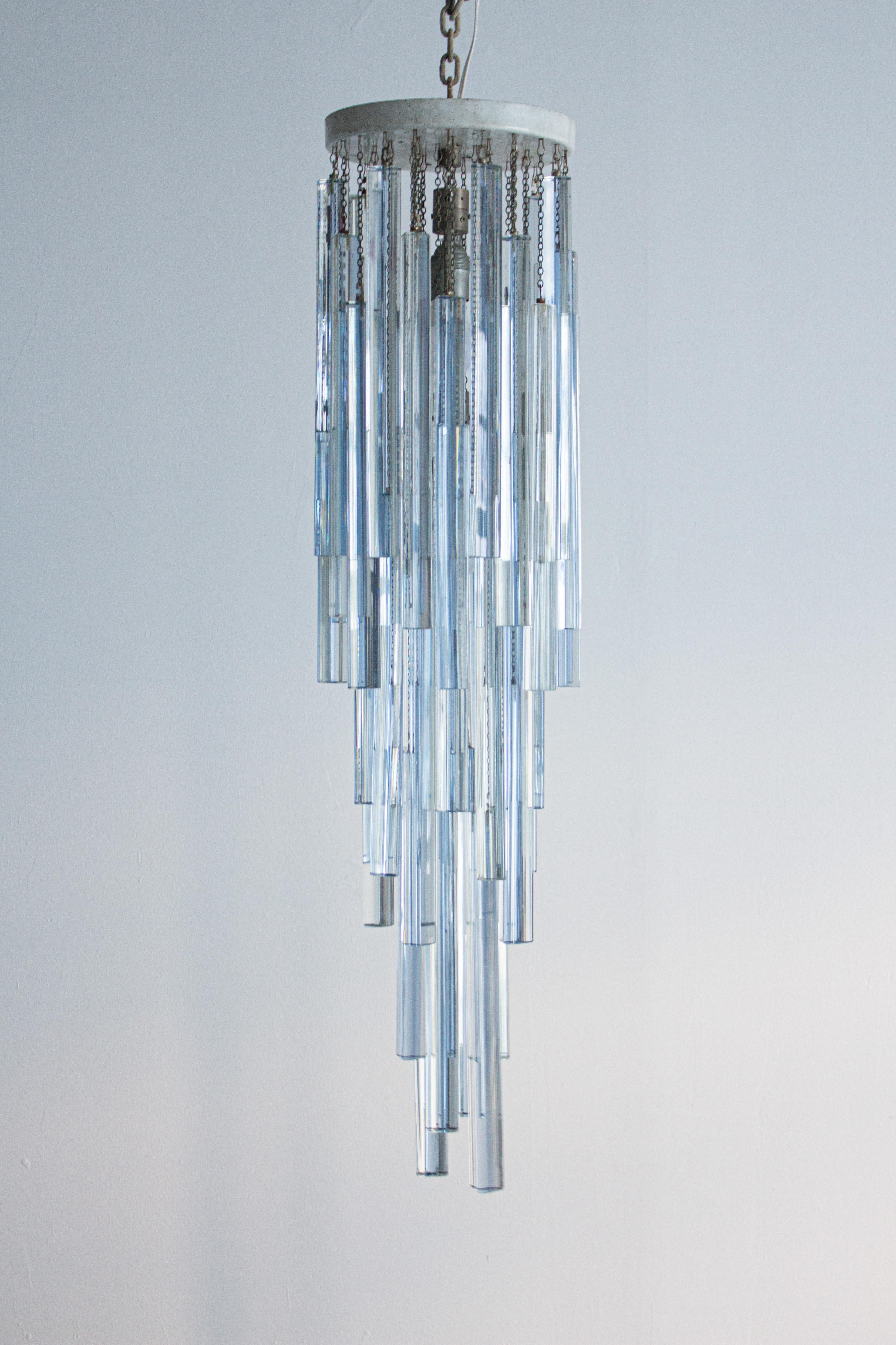A Venini Murano glass chandelier. Cascading “triedri” prisms in both ice blue and clear glass dangle from chains attached to the flush mount canopy. Several extra prisms included. Flush mount canopy measures 9.5” wide by 1.25” deep. Original wiring