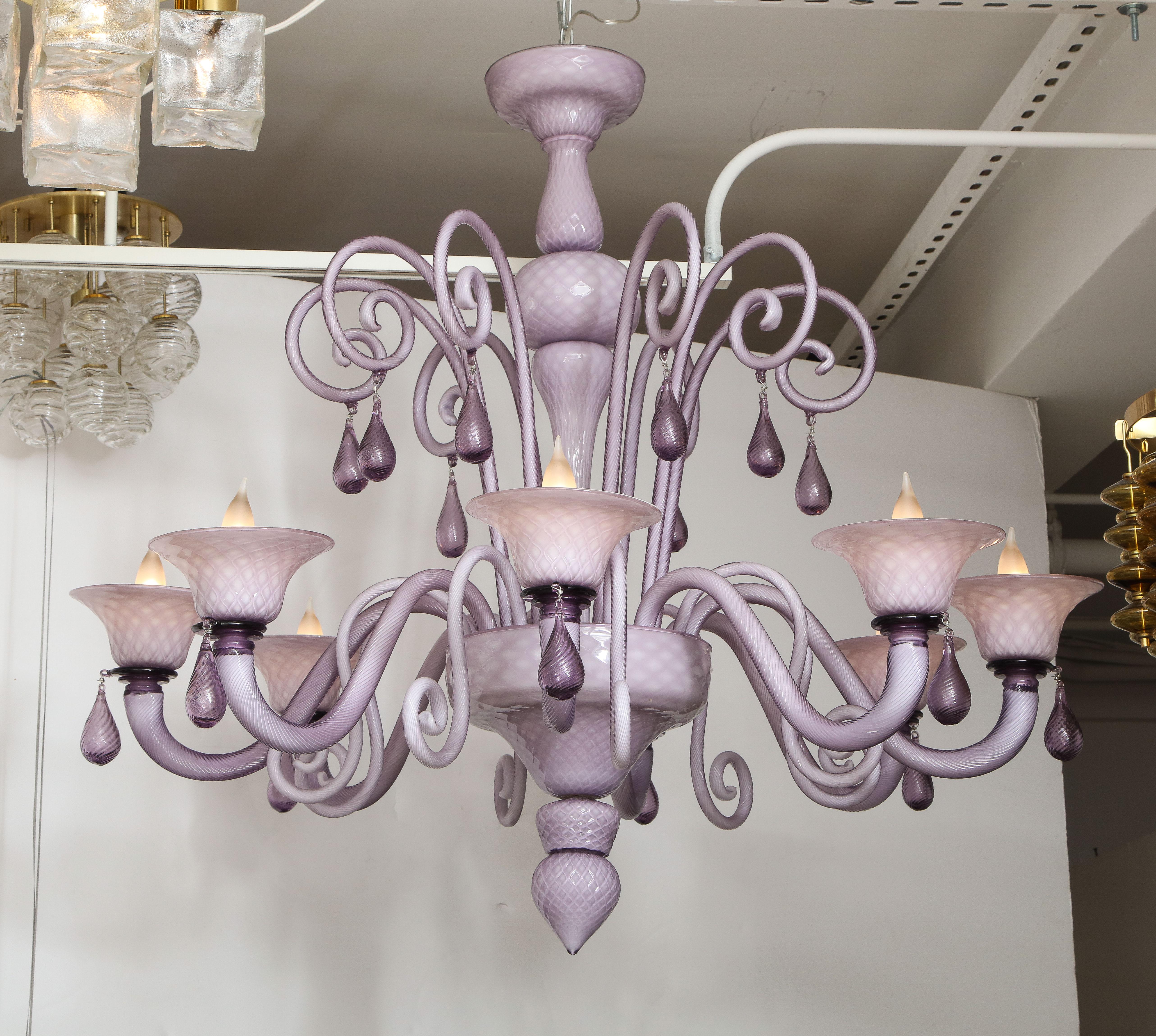 Impressive 8 arm Murano glass chandelier featuring decorative hand twisted cane finials and lilac drops. Glass body is a distinctive cased lilac over white glass with a 