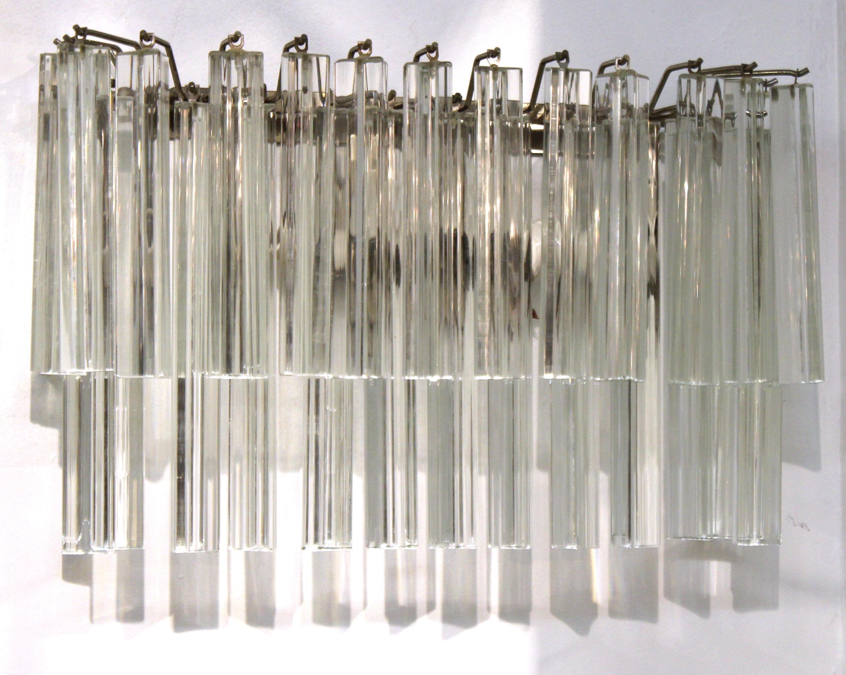Italian modern sconces by Venini, each one with two tiers of hanging glass prisms on a metal frame. The pair is in great vintage condition with age-appropriate wear.