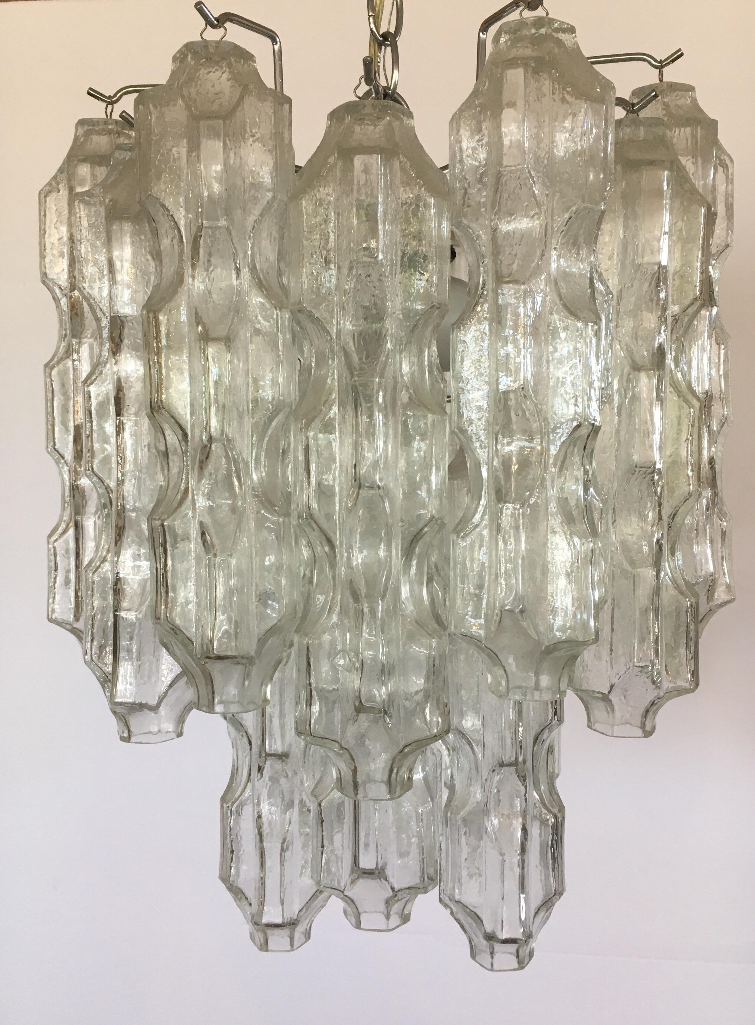Magnificent Venini 1960s Murano glass tubular chandelier. Made in Italy and features textured tubular Murano glass cylinders that hang individually. Nothing short of spectacular. Three light sockets in the interior and wired for USA and in perfect