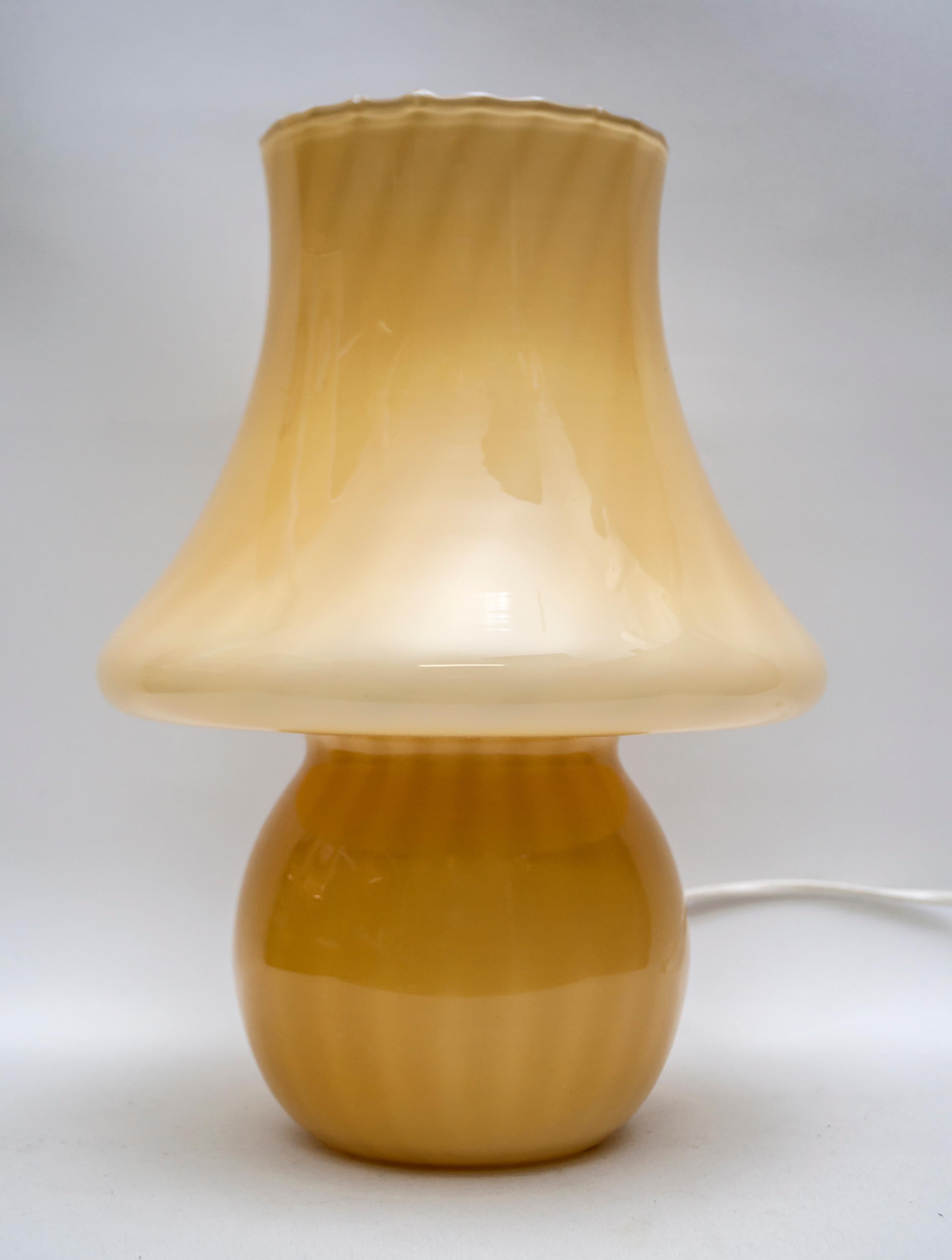 This mushroom lamp in Murano glass was produced by Venini in the 1970s.

For over ninety years the Venini brand has been characterized by craftsmanship and tradition in the international glass objects market. The first artistic director Vittorio
