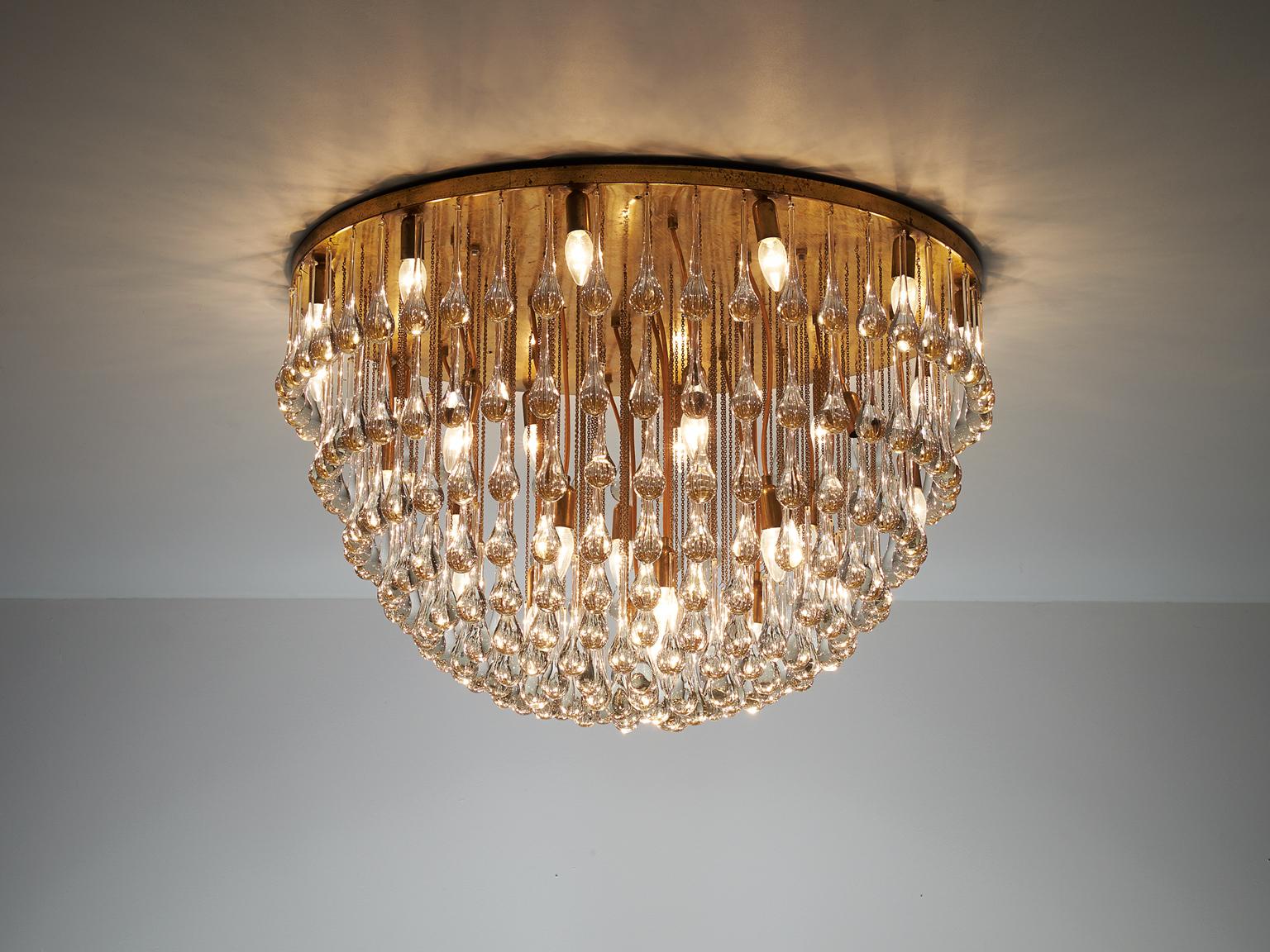Chandelier in brass and glass, attributed to Venini, Italy, 1960s. 

Majestic chandelier with a large amount of glass drops. This royal lamp creates a stunning light partition. The glass icicles combine together into a large globe. In combination