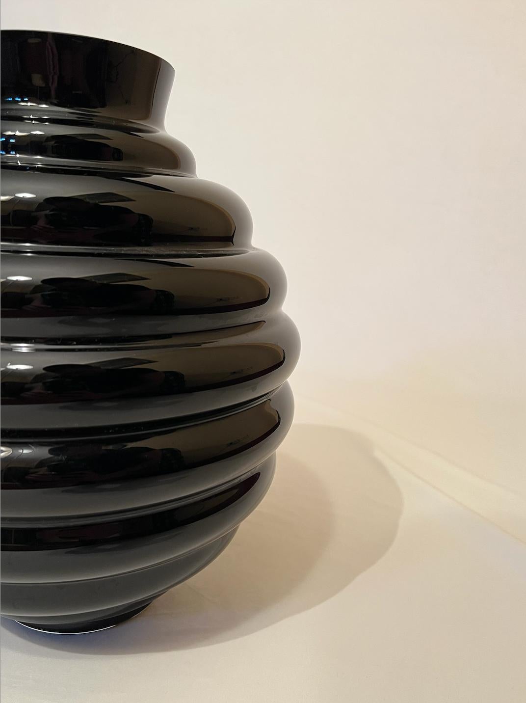 Black opaline blown glass vase obtained by overlaying lattimo with other glass, opaline glass is hand-blown and hand-worked. Made by deep back glass and stratified with different layers or circular glass. Design inspired by Venini's vase, designed
