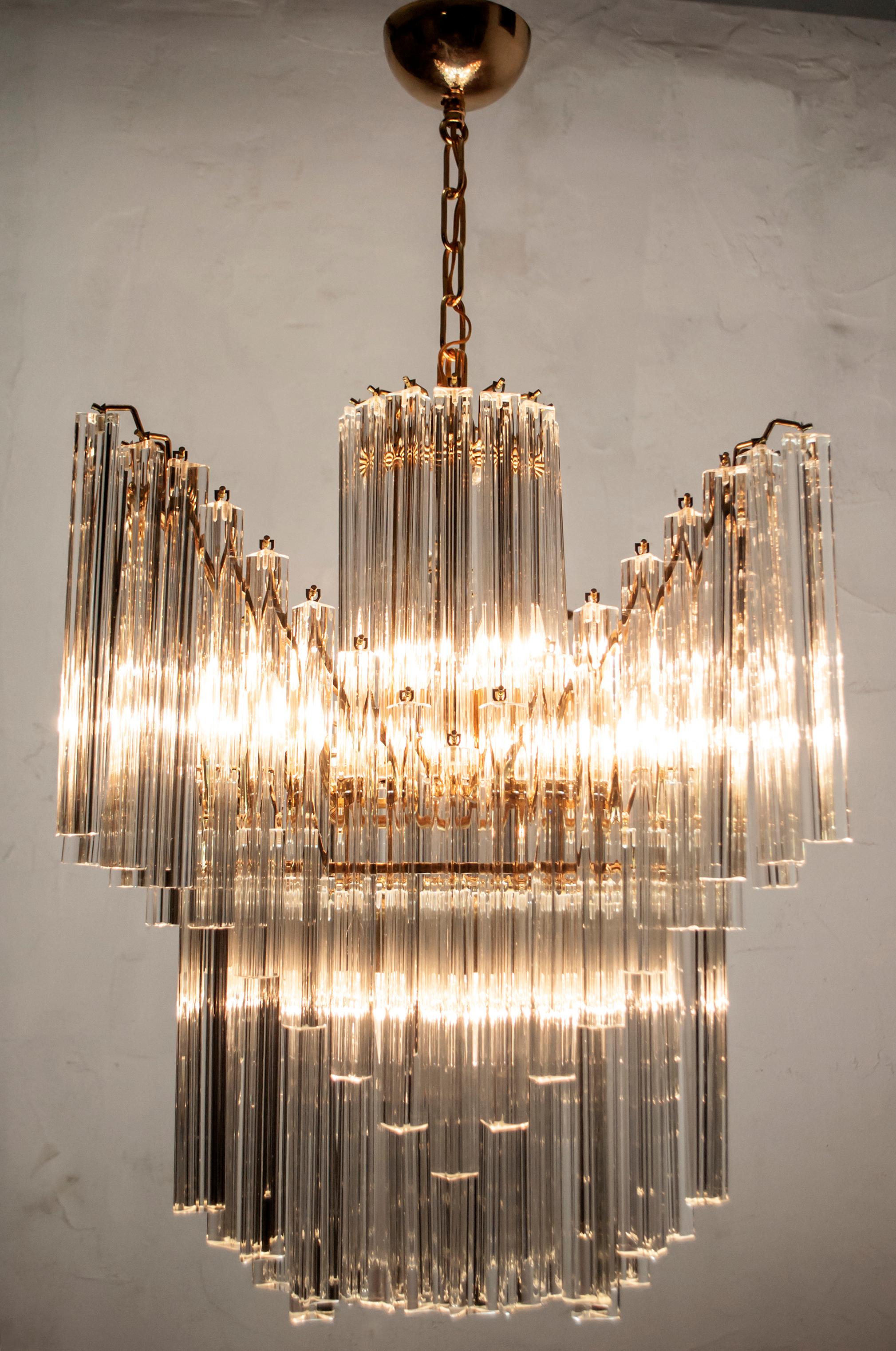 This six-light chandelier is made up of 94 Triedri in Murano glass and was produced by Venini in the 1960s, it has a three-pointed shape and a golden brass structure. The exact height, removed the chain, is 65 cm.

Paolo Venini (1895-1959) emerged