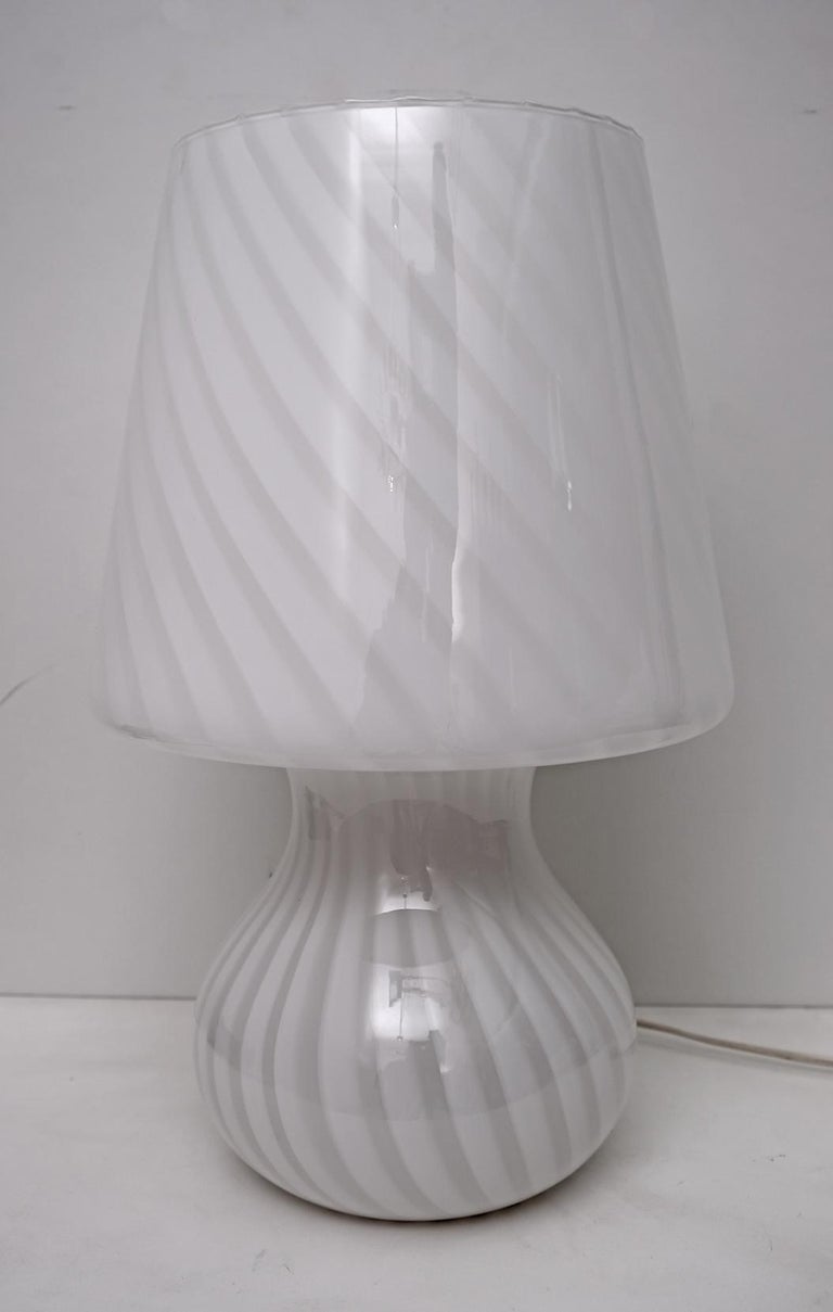 This mushroom lamp in Murano glass was produced by Venini in the 1970s.

For over ninety years the Venini brand has been characterized by craftsmanship and tradition in the international glass objects market. The first artistic director Vittorio